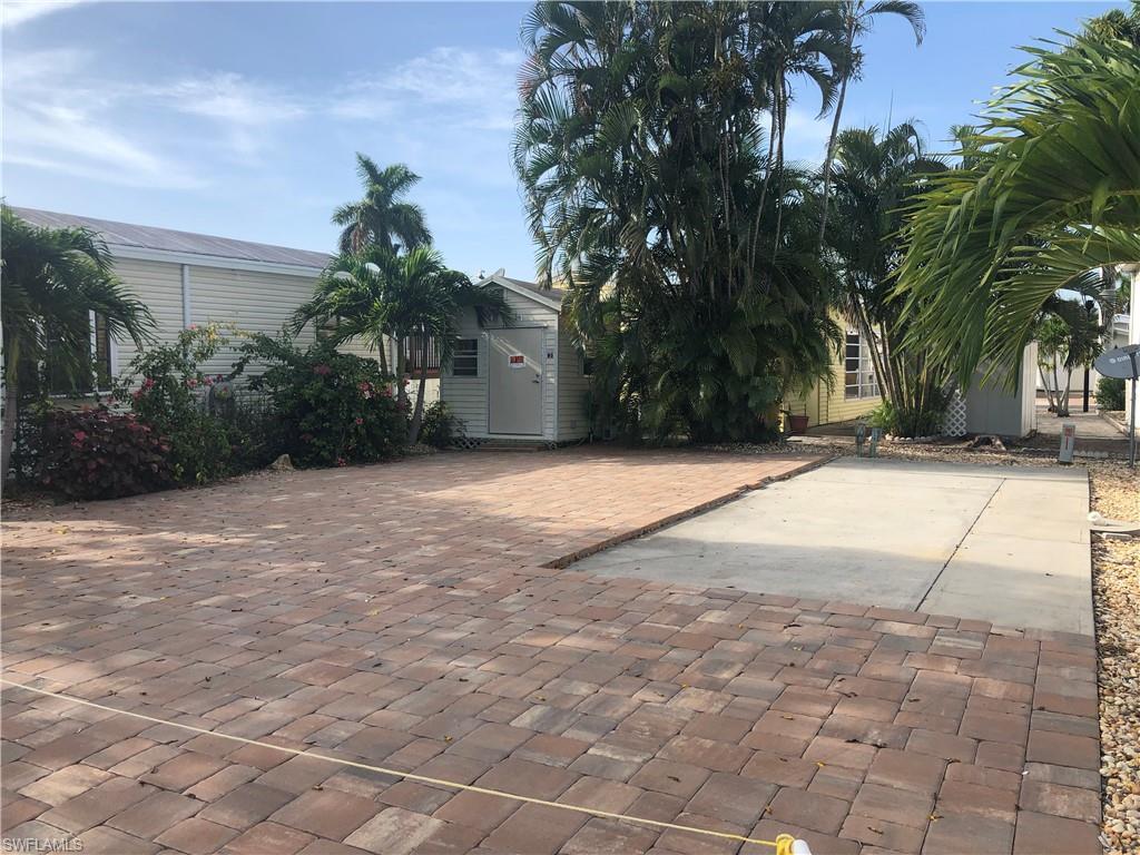 Come claim your slice of paradise! This rarely available, lovely space is located in an active 55+ community and will accommodate a mobile home or an RV up to 34 feet. Upgraded with pavers and storage shed and complete with connections, this lot is ready for your new RV or mobile home. America Outdoors is a gated community where homeowners own the land and live maintenance free with LOW fees and GULF ACCESS via boat ramp! Enjoy the Florida lifestyle in this active, amenity rich, pet friendly community! BRAND NEW clubhouse. This one is a great value and won't last long!