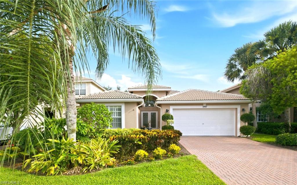 Immaculately maintained, this stunning three bedroom two bath Egret floor plan is ideally situated on Isla de Palma Circle within the highly sought-after, amenity-rich community of Saturnia Lakes in North Naples.
Upon entering through the double glass front doors, you are welcomed by a bright and spacious open-concept design featuring soaring 13-foot ceilings, abundant natural light, and an inviting atmosphere. Two sets of sliding glass doors seamlessly connect the indoor living spaces to the extended screened lanai, where a private custom shaped curved pool and built-in spa overlook lush tropical landscaping and a tranquil fountain, creating the perfect setting for relaxing or entertaining.
The updated kitchen serves as the heart of the home, featuring a large center breakfast bar with seating for four, granite countertops, solid wood cabinetry, and stainless steel appliances.  The oversized primary suite serves as a private retreat, offering peaceful views of the pool and a tranquil setting designed for relaxation. This sophisticated haven also features dual walk-in closets and a spacious bath complete with dual vanities, a soaking tub, and a remodeled walk-in shower. Two tastefully appointed guest bedrooms have been thoughtfully designed with elegant décor and finishes, creating comfortable and inviting accommodations for family and visitors. Currently configured as a private guest retreat, one room serves as a spacious bedroom while the other functions as a cozy TV lounge or den, offering a secluded haven for guests complete with a full bath. Combining elegant living spaces, desirable amenities, and an exceptional North Naples location, this refined residence offers the ultimate in comfort, convenience, and destination living.
Residents of Saturnia Lakes enjoy an exceptional array of resort-style amenities, including a clubhouse, resort and lap pools, kiddie pool, hot tub, saunas, fitness center, four lighted Har-Tru tennis courts, basketball court, playground, billiards room, ballroom, and internet café. Ideally located within top-rated school zones and offering resident access to Logan Boulevard for convenient commuting, this prime North Naples location is just minutes from pristine Gulf beaches, premier shopping, dining, and entertainment. This extraordinary residence is one you will not want to miss.