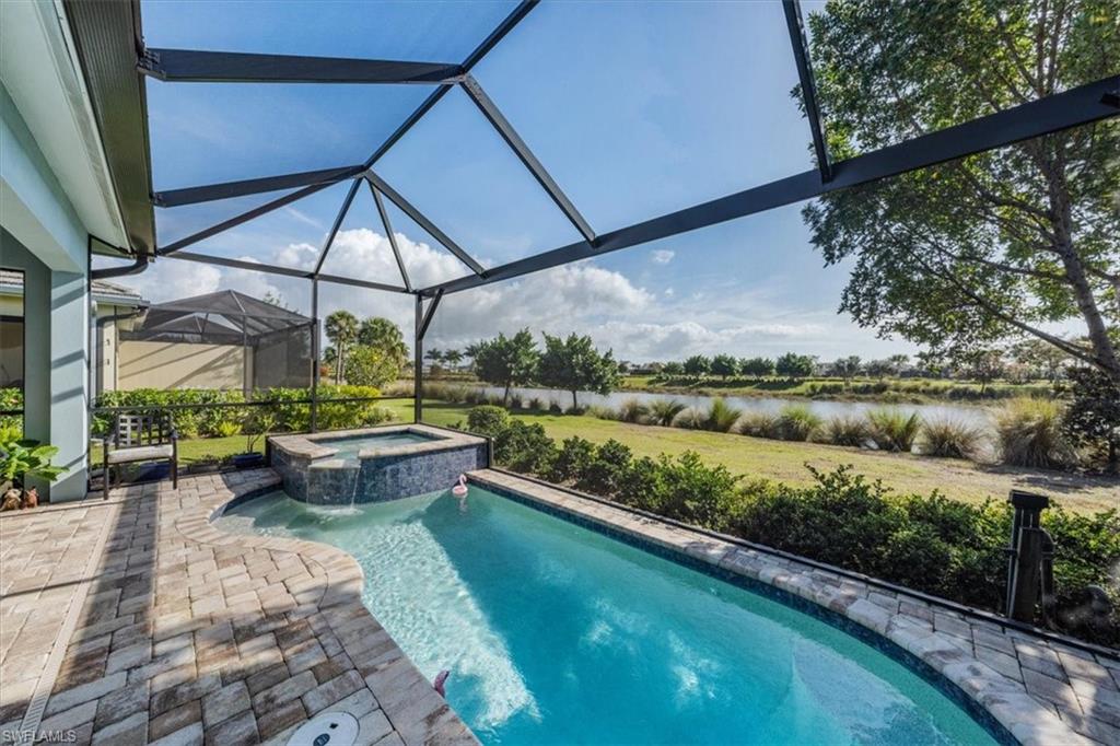 V4300 - WOW!! This beautiful "Dahlia" Villa is being is being sold "Turn-Key", just fill up the fridge, and start the party, you are all moved in with No aggravation! This Villa feels like a new home. Bright and sunny, with Southern exposure. One of the best locations in the Isles!  Many builder upgrades!.  Enjoy your coffee or glass of wine on the lanai with private heated pool and spa, where you can enjoy Panoramic views of Nature & Lake.  Owner suite bathroom has Carrera marble & custom walk-in closet. Plantation shutters. The living room has an electric fireplace. Grey wood plank tile flooring in Living areas. Kitchen has all white cabinetry, white quartz countertops and stainless appliances. 2 car garage has automated lift "In Storage" system. Impact windows and doors.  The "Isles" oneof Naples best kept secrets, built by "Minto", a 'Green builder". Grab a Kayak at the Clubhouse, swim a few laps in Lap Poolenjoy cocktails, lunch or dinner at the Overlook Bar and Restaurant.  Plenty of Nature Walking Trails & bike paths. If Pickle ball is your sport, you are in luck, this is the favorite sport in The Isles.  Too many features and Amenities to list here!