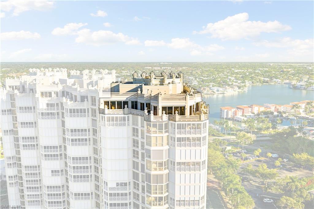 Ascend to the absolute height of luxury in this commanding Penthouse residence at The Brittany, where the sky meets the shore in prestigious Park Shore. Offering a rare combination of single-family estate scale and high-rise ease, PH-11 spans an impressive 6,543 square feet of air-conditioned living space, delivering a lifestyle of uncompromising grandeur and privacy.

From the moment the keyed private elevator opens into your gracious foyer, you are greeted by breathtaking, unobstructed views of the Gulf of America and Venetian Bay. Soaring 10-foot ceilings and expansive floor-to-ceiling glass walls flood the residence with natural light, creating an airy, ethereal atmosphere that can only be found at the top. The sprawling floor plan features 6 spacious bedrooms plus a den/study and 6.5 baths, anchored by a magnificent Grand Salon with one of two fireplaces—a rare find in beachfront condominium living.

Designed for the ultimate entertainer, the residence boasts vast wrap-around terraces that offer panoramic vistas from sunrise to sunset. The crown jewel of this penthouse is the private rooftop sun deck, an exclusive sanctuary for sunbathing or starlit gatherings. The lavish primary suite is a retreat unto itself, featuring a sitting area, an adjacent study, and a spa-inspired bath, all framed by captivating water views. Additional luxuries include a private in-residence exercise room complete with a sauna and incredible storage throughout.

Ownership of PH-11 includes the coveted unparalleled perk of a private poolside cabana and 3 deeded parking spaces. Residents of The Brittany enjoy world-class amenities, including a beachfront pool and spa, tennis courts, fitness center, guest suites, and 24-hour security. Located just a short stroll from the upscale dining and shopping of Venetian Village, this is more than a home; it is a legacy property for the most discerning buyer.