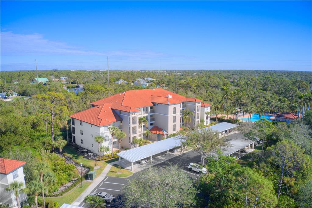 Location and condition come together beautifully in this third floor condo in Pelican Sound River and Golf Club. A former model backing to preserved land, it combines rare privacy with treetop scenery for a peaceful setting. The living room includes an 75 inch Sony smart TV. The kitchen is a cook’s dream, professionally installed in 2022 with Kraftmaid cabinets, pull out shelves, a tray and cookie sheet cabinet, pull out lazy Susan, a Blanca sink with hand activated gooseneck faucet and sprayer, and top level quartz counters with an extended breakfast bar. Black stainless appliances include a dishwasher with utensil shelf and adjustable rack, self cleaning oven, cooktop with warming element, microwave, pantry, and a coffee bar with a glass front upper cabinet. All doors and drawers are quiet close.

Ceramic tile (18 x 18) is laid on the diagonal throughout, with carpet only in the bedrooms. The primary bath features an added floor to ceiling linen closet and a new walk in shower with tumbled stone floor, porcelain tile walls, a new floor pan, and a clean, doorless entry. You will also find double sinks, a medicine chest, and a spacious vanity. Both the walk in closet and double closet have been professionally customized by Closets by Design.

The hall bath includes a fiberglass tub with rain shower head, medicine chest, vanity with drawers, and a linen closet. The guest bedroom offers plantation shutters, a Closets by Design double closet, and a ceiling fan with light. The laundry area includes a washer, dryer, cabinets, and overhead lighting.

Additional improvements include a 2023 air conditioner with UV light. A large storage unit is also available. You are just a three minute walk to the Island Sound pool and spa and an easy stroll to the tennis and pickleball complex.

Pelican Sound is a bundled, gated community with three entrances, two staffed full time and one owner entrance. The annual fee includes golf, seven pools, two clubhouses with restaurants, two large dog runs, state of the art bocce courts, 27 holes of superior golf, a free boat shuttle to Lover’s Key Beach, boat launch, kayaks, row boats, a new fitness center with community rooms, a library, and a racquet center that is the envy of the area. Shopping, dining, and services are only minutes away, with a quick drive to interstate 75 and an easy 20 minute trip to Fort Myers International Airport.

This is a wonderful place to call home or enjoy as a second home.