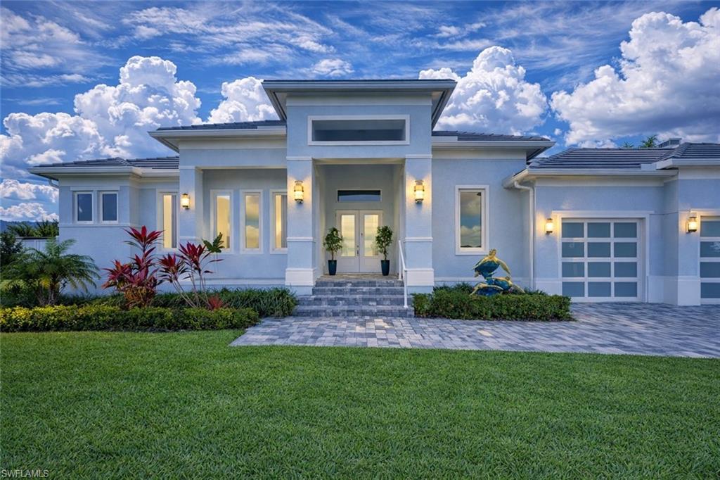 LOWEST PRICED NEWER CONSTRUCTION SINGLE FAMILY HOME ON HALF ACRE LOT IN MARCO ISLAND! Exquisite Coastal Estate – Steps from the Gulf, Half-Acre Lot, and Fully Customized. This stunning 4-bedroom plus den, 3-car garage residence sits on a rare half-acre homesite in one of the most exclusive estate neighborhoods near Marco Island—just steps from the shimmering waters of the Gulf. Caxabas & San Marco Marina are just minutes away! Built with elevated design and having sustained no hurricane damage, this home offers the perfect blend of safety, sophistication, and seaside luxury. Inside, you’ll find soaring vaulted ceilings and a bright, coastal-inspired interior that’s filled with natural light. Wide-plank tile flooring runs throughout, anchoring an open layout that flows effortlessly from the living area to the dining area to the entertaining space. The custom kitchen is a chef’s dream, complete with quartz countertops, sleek white cabinetry, double wall ovens, and a large island perfect for gathering. A built-in wet bar adds a touch of elegance, ideal for hosting or everyday enjoyment. Glass sliders open to an expansive covered lanai, where an outdoor kitchen, TV lounge, and a custom-designed pool and spa with elegant water features create your own private resort. A 500-gallon underground propane tank fuels the built-in BBQ & generator. The oversized yard is beautifully landscaped, offering space and privacy rarely found this close to the Gulf. The primary suite is a true retreat, featuring direct access to the outdoor living space, dual walk-in closets, and a luxurious spa-style bathroom with a glass-enclosed walk-in shower and a dramatic freestanding soaking tub. A dedicated home office with large windows provides inspiring views and abundant natural light, making it a productive and peaceful workspace. This is a rare opportunity to own in a high-end coastal enclave with no HOA restrictions, quick access to the open Gulf waters, and every feature today’s buyers are looking for. Whether you’re seeking a full-time residence or a high-performing rental investment, this home delivers on all fronts — location, design, and lifestyle. One or more photo(s) has been virtually staged, AI-generated, or rendered.
