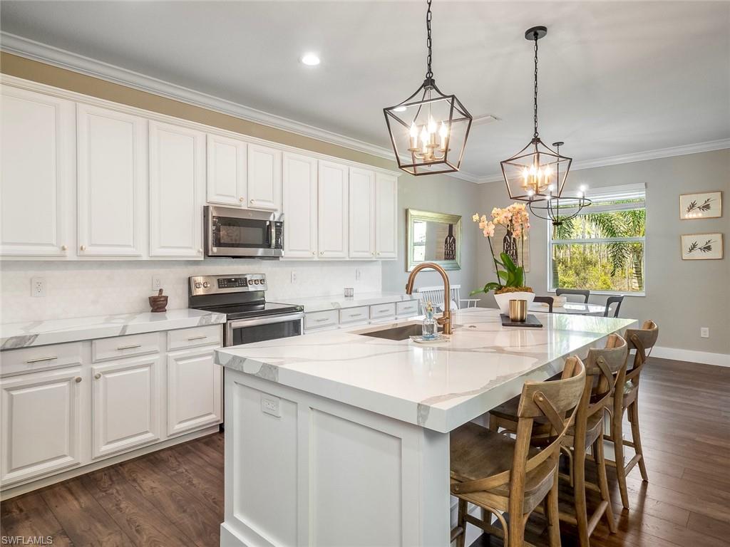 ONE OF A KIND! See the pride in ownership in this custom, elegant 5 bed plus Loft ~ 4.5 bath home that will impress you from the moment enter through the front door. Entertaining? This gorgeous kitchen boasts beautiful white wooden cabinetry, quartz countertops, upgraded appliances and a large island drawing friends & family to gather in the great room, or open the slider wall for an outdoor area awaiting your design. Neutral tones and extensive luxury plank laminate flooring, the spacious living areas lead to split bedrooms ensuring privacy, perfect for a growing family or plenty of visiting guests. Also features a New roof in 2018! Second story loft with work area perfect for a home office or school space for the kids. This premium lot offers plenty of privacy and a preserve setting with plenty of room for a custom pool. Bella Terra has a Resort-style Clubhouse and pool/spa, 24 hour fitness center, activities for all ages, shaded children's play area, tennis courts, pickle ball, bocce ball, sand volleyball, soccer/softball/hockey/football fields, tranquil butterfly garden, walking trails and much more....and the best part is the LOW HOA fees you get in beautiful Bella Terra!