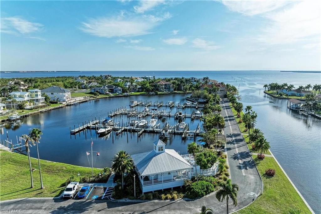 Welcome to Grassy Point Estates — Port Charlotte’s premier gated waterfront enclave, where privacy and luxury meet the best of Florida coastal living. This exceptional homesite is perfectly positioned within a protected marina basin, offering peace of mind and quick access to Charlotte Harbor and the Gulf of Mexico. Surrounded by high-end luxury residences, this lot presents an outstanding opportunity to build your custom dream home at a highly desirable price point. Residents of this exclusive community enjoy a 24-hour guarded entry, private marina with deeded boat slips, and beautifully maintained grounds framed by lush tropical landscaping. Included with the property is deeded slip #A-5, ideally situated near the seawall within the private marina for added protection and convenience — providing a shorter walk and easy access to your boat. Grassy Point’s location places you moments from downtown Punta Gorda’s waterfront dining, boutique shopping, walking trails, and lively festivals — as well as the area’s world-class boating, fishing, and pristine Gulf beaches. Don’t miss this opportunity to own within one of Southwest Florida’s most distinguished gated communities and create your ideal coastal retreat in the heart of Punta Gorda.