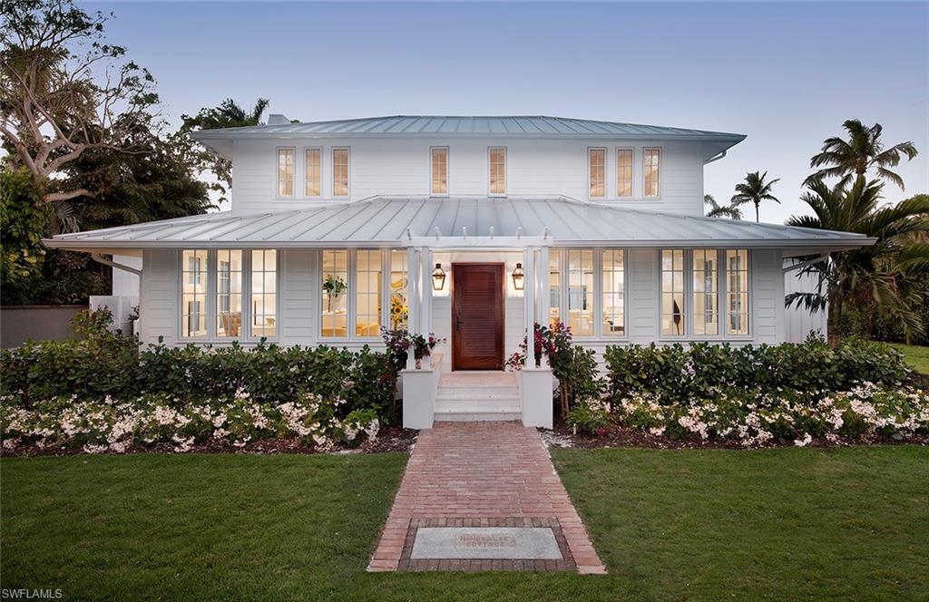 The historic Immokalee Cottage (a/k/a the Wedding Cottage) c. 1920 is a prominent landmark property located in the heart of Olde Naples and within steps to the beach, and a block to celebrated 3rd St. amenities.  This property truly represents a once in a lifetime opportunity to own one of the most extraordinary properties in Olde Naples.  A very unique compound set upon an oversized 115x150 lot featuring a completely modernized main home, two renovated 1-bedroom cottages, and a new 2-car carriage house with storage - all wrapped around one of the finest outdoor living areas in town.  This complete and total renovation includes an open floor plan and a grand first floor master suite - each opening onto an expansive resort-inspired patio, pool, and spa area. Late afternoons and early evenings can be made even more delightful by enjoying the outdoor fireplace after a day at the beach or after enjoying the 3rd Street restaurants and shops.
