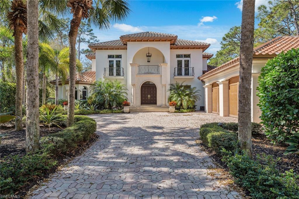 New Roof 2026. Masterfully designed, updated and elegant, this exceptional estate home on a beautifully manicured street within Colliers Reserve. This spacious, light-filled residence welcomes you through oversized solid mahogany double entry doors into an awe-inspiring grand foyer showcasing 22-foot soaring ceilings, diagonally set marble floors, and a magnificent sweeping curved staircase with marble treads and wrought-iron railings accented by a solid brass banister. Light and airy interiors are enhanced by designer lighting and window treatments, rich oversized crown moldings and exquisite millwork throughout. The chef’s dream kitchen features a Thermador five-burner gas cooktop, wood-paneled vent hood with polished and tumbled marble detailing, upper- and under-cabinet lighting, a Thermador thermal wall oven and elegant granite countertops with seating at the center island. Custom 8-foot solid wood doors are featured throughout the home. The primary suite bath offers a spa-like retreat with dual marble vanities, a frameless walk-in shower and a Mirabelle Therapy bubbler soaking tub. Designed for effortless entertaining, the home offers a separate bar area and a beautifully styled wood-accented covered outdoor living space ideal for gathering with family and friends. A Lutron lighting system with programmable features integrates seamlessly with a Savant home automation system. A private office or den showcases custom raised-panel natural-finish entry doors, rich wood paneling, crown moldings and wide-plank royal mahogany wood floors. Outdoors, enjoy peace and serenity around the oversized 35-by-16-foot sparkling lap pool and raised spa, framed by lush greenery and tranquil views of the preserve and golf course. Colliers Reserve is proudly designated as an Audubon Signature Sanctuary, spanning over 450 acres of pristine natural beauty and lush landscaping and is an unmatched setting in Southwest Florida.