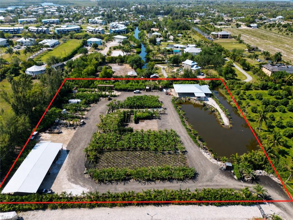 SELLER FINANCING AVAILABLE!!!
Your shortcut to island living starts here.
Welcome to your private slice of paradise on Pine Island. Set on 2.5 acres, this property is already prepped and packed with opportunity the clearing and elevation is done, so you can skip the heavy lifting and jump straight into bringing your vision to life.

Tucked away at the very end of a quiet dirt road, this peaceful setting is surrounded by other large parcels, offering both privacy and room to grow. A serene salt water pond borders the west side, adding a natural focal point and tranquil views.

Zoned agricultural, this land is incredibly versatile design your dream homestead, start that boutique farm or nursery, or create a private retreat complete with a custom home, pool, and barn. With approximately 200 palm trees already on the ground included in the sale (standing palms do not convey), you’ve got a head start on landscaping or business potential.  What truly sets this property apart are two brand-new wooden covered structures beautifully built and perfect for hosting gatherings, parties, family reunions, or even creating a unique event space. Whether you're entertaining under the island breeze or planning something bigger, the setup is already here.

Utilities are already in place, with electric on site and a well. fed irrigation system covering the entire property ideal for maintaining lush greenery year round.

Life on Pine Island is all about slowing down and soaking it in. Known for its laid-back charm, the island offers scenic bike paths, a local K–5 school, fresh-caught seafood, and endless kayaking opportunities. Surrounded by Gulf waters, you’ll also have access to some of the best shallow water fishing in the world.

Whether you're looking to build, invest, or create something truly unique this property delivers the space, setting, and flexibility to make it happen.