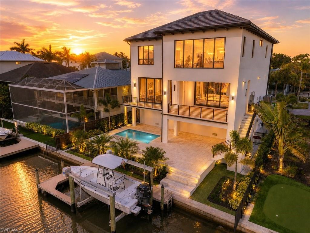 MOVE-IN READY | NEW CONSTRUCTION | GULF HARBOR — NORTH NAPLES
Brand-new 4BR/4.5BA waterfront residence in one of North Naples' most sought-after boating communities, just west of U.S. 41. First living level elevated to 16 feet for exceptional storm surge protection. 10-15 minute boat access to Wiggins Pass via your private 10,000 lb lift, accommodating vessels up to 28 feet.
Inside, 3,871 sq ft of open-concept living features soaring ceilings, walls of glass, premium finishes, and a chef's kitchen. The expansive pool deck and outdoor dining area are built for the Naples lifestyle. Total footprint of 6,236 sq ft including storage, garage, and outdoor space.
Gulf Harbor is a private enclave of ~150 single-family homes 

STANDARD FINISHES & FEATURES

Porcelain tile for bath areas and outdoor balconies
Pre-wired for smart home technology and automated shading
Flush mounted LED lighting plan
Solid core wood doors throughout
Thermal tinted impact glass; Miami-Dade hurricane 2023 code
Tankless Propane Hot Water Heater
Two 4-Ton HVAC units
Wide plank Legno Bastone® hardwood flooring throughout
Prepped Elevator Shaft
$20,000 Credit for Closet Design
KITCHEN & BUTLER PANTRY
Custom designed cabinetry
Pompeii® quartz countertops with 3” mitered edge and waterfall island detail
Brizo plumbing fixtures
Under cabinet electric and LED lighting
Silgranite sink in Kitchen and Butler pantry
Subzero® designer series 18” column wine refrigerator
Subzero® designer series 30” refrigerator & 30” freezer
2 Subzero® 24” wide beverage drawers
Wolf® 48" 6-burner sealed gas range top
Wolf® 30” E series built in convection oven
Wolf® 30” E series built in speed oven
Bosch® dishwasher with cabinet panel
Cabinet Hardware
LIVING ROOM
Cove lighting feature
Gas stub for fire place
10ft sliding glass doors by PGT
Prewired for shading
POWDER BATHROOM
Custom designed cabinetry
Natural stone countertop
Kohler toilet
MASTER SUITE
Midnight Bar
Sub-Zero® 24” Designer Undercounter Refrigerator
Custom designed cabinetry
Pompeii® quartz countertops
Porcelain 24 x 48 tile
Brizo plumbing fixtures
Custom soaking tub
Large seamless glass shower enclosures
Kohler Toilets
Cabinet Hardware
LAUNDRY ROOM
Electrolux® front load washer & dryer
Custom designed cabinetry
Oversized laundry sink
Hanging clothes rod
Pompeii® quartz countertops
OUTDOOR LIVING
Lynx® Sedona 36" Built-in Grill with rotisserie
48" Pro-style Stainless Steel Outdoor Vent Hood with 1300 CFM blower
Concealed roll down Hurricane Shutters and Insect Screens
Access doors below grill for storage
Pre-plumbed for outdoor sink
WAC outdoor lighting
STRUCTURE & RESILIENCY
26KW Generator
500 Gallon Propane Tank
Concrete Block Construction and 10” Poured Wet Decks
Deep Pile Foundation
Poured in Place Concrete Stairs (Interior and Exterior)
Concrete Roof Tiles by Eagle with Coastal Resiliency Package
R-30 Open Cell Foam Insulation Roof Deck & Soffit Wrap Back