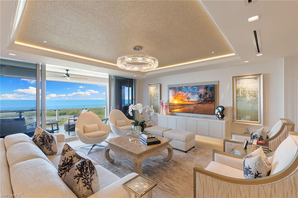 Coastal luxury at Mystique in Pelican Bay. Perched on the 12th floor of Pelican Bay’s newest and most exclusive high-rise, Mystique, this extraordinary residence offers sweeping views of the Gulf and unforgettable sunsets framed by expansive floor-to-ceiling windows. Every detail of this home exudes sophistication and timeless elegance. A renowned interior designer has curated a stunning palette highlighted by exquisite wall and ceiling coverings, custom lighting and Legno Bastone Italian wood flooring. The pristine white kitchen is a showpiece of modern refinement, featuring Carrara marble countertops and a striking black-and-white tile backsplash. The den/piano lounge features a dramatic backlit Crystallo bar with Crystal sink and custom marble fireplace. Pocketing doors open at the touch of a button in this smart home with custom Lutron system. No expense has been spared in creating this extraordinary coastal sanctuary. Residents of Mystique enjoy the ultimate in five-star living with 24-hour concierge service, and an array of world-class amenities. Within the private Pelican Bay community, indulge in exclusive beach access with two beachfront restaurants and bars, chair and umbrella service, tennis and pickleball courts, a state-of-the-art fitness and wellness center, and miles of scenic recreational and biking trails. Just moments from Artis-Naples and Waterside Shops, Mystique offers a lifestyle of unmatched convenience, culture and sophistication. This is more than a residence, it’s an elevated way of life on the Gulf.