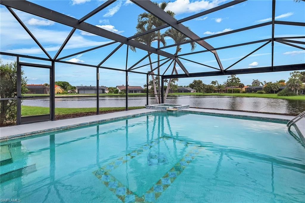 If you are looking for a home close to the beach, dining, shopping, and entertainment you have found it! On a one-of-a-kind, oversized 0.39-acre tip lot at the end of a quiet cul-de-sac, this beautifully maintained three-bedroom, 2.5-bath home offers spectacular panoramic lake view and exceptional privacy with a wooded area bordering one side. The outdoor area is designed for seamless indoor-outdoor entertaining and features an unusually large residential pool, a relaxing spa, a custom kiddie pool, and an expanded paved patio area, ideal for lounging in the sun. A convenient pool bath and an outdoor shower complete this backyard paradise. Inside, the kitchen is ideally positioned for entertaining, sitting directly adjacent to the outdoor pool seating area and connected by sliding glass doors that provide seamless access to the lanai. It features upgraded cabinetry, granite countertops, stainless steel appliances, a pantry cabinet with pullout drawers, and a reverse osmosis water system for the kitchen sink and refrigerator. The spacious primary suite offers dual walk-in closets and a primary bath complete with a separate tub and a walk-in shower, double vanities and a dedicated makeup station. On other side of the home, two comfortable guest bedrooms share a recently renovated full bath. Located west of U.S. 41 in the gated community of Vanderbilt Lakes, this exceptional property is just minutes from Barefoot Beach and Bonita Beach, two of Southwest Florida's most beautiful Gulf beaches.  With its breathtaking water view, resort-style outdoor living and unmatched privacy, this home offers a unique opportunity to enjoy the best of Southwest Florida living.