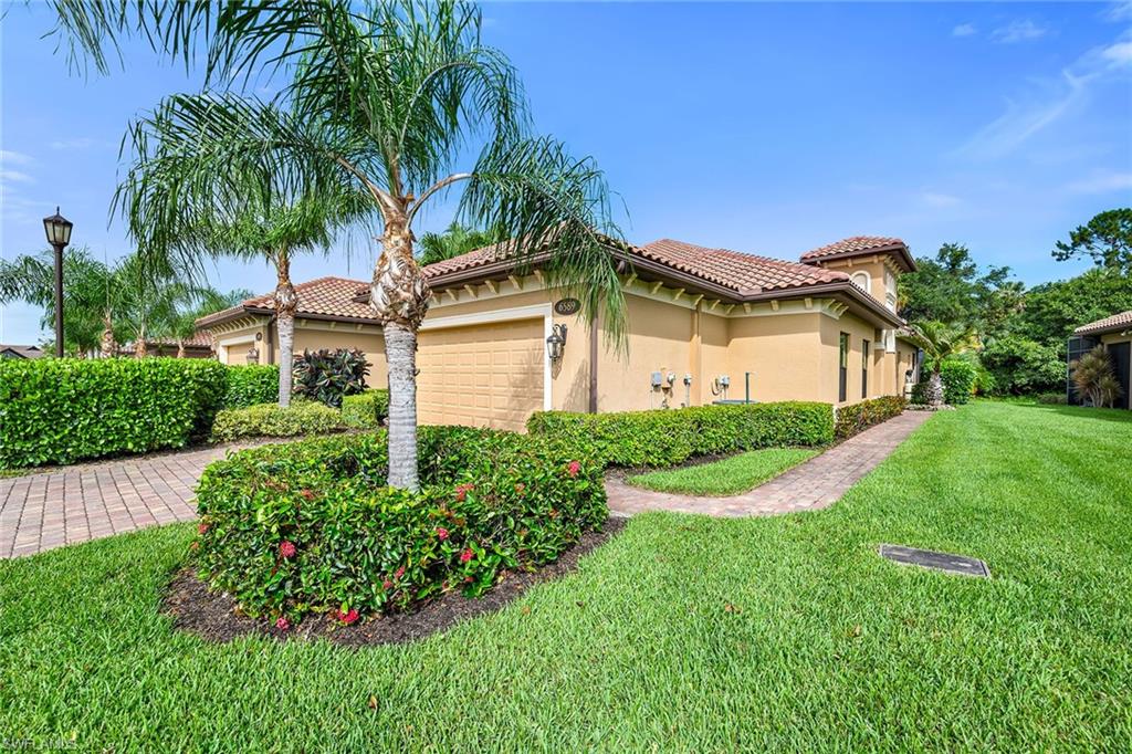 Located within Lakoya, the gated luxury enclave of Lely Resort, this private Capri model offers three bedrooms, two baths and a two-car garage, along with mandatory membership to the renowned Players Club and Spa. Designed for seamless indoor-outdoor living, the open floor plan flows to a spacious screened lanai featuring a covered sitting area with ceiling fans, a built-in gas grill with a propane tank, a saltwater heated pool and spa and ample space for entertaining or enjoying peaceful Florida evenings. Inside, the thoughtfully designed residence showcases tile flooring throughout the main living areas, plantation shutters, tray ceilings and impact doors/windows. The living room features tile flooring, a ceiling fan and sliding glass doors that open directly to the lanai, creating an effortless connection between indoor and outdoor spaces. The kitchen is equipped with premium stainless steel appliances, including a Bosch refrigerator/freezer with icemaker, dishwasher, microwave and range. Adjacent to the kitchen, a breakfast nook provides a comfortable space for casual dining, while the separate formal dining room offers an elegant setting for gatherings and special occasions and could also serve as a flexible space to suit a variety of lifestyle needs. As part of a natural gas community, the home offers added efficiency and convenience. The spacious primary suite features carpet flooring, a tray ceiling, a ceiling fan, a walk-in closet with custom cabinetry and glass sliding doors opening to the lanai. The en-suite bath includes dual sinks, a glass-enclosed walk-in shower, a separate soaking tub and an enclosed water closet. One guest bedroom offers carpet flooring, a ceiling fan, a closet and access to an en-suite bath with a shower/tub combination. The second guest bedroom also features a ceiling fan and closet, providing comfortable accommodations for family and visitors. Additional highlights include a dedicated laundry room with a washer and dryer, a laundry tub and custom cabinetry for storage and organization. The air-conditioned two-car garage features additional built-in storage cabinetry, providing exceptional space for organization. Furniture is negotiable, and the sellers have provided a list of exclusions. Lakoya residents enjoy exclusive access to the mandatory Players Club and Spa, featuring multiple resort-style pools, several dining venues, tennis and pickleball courts, a full-service spa, a large fitness center and dedicated aerobics rooms. Golf enthusiasts will appreciate Lely Resort’s three championship golf courses with membership opportunities available. Ideally situated just 10–15 minutes from downtown Naples, this home is close to upscale shopping, acclaimed dining and Southwest Florida’s beautiful beaches. In the desirable X-500 flood zone, no flood insurance is required. Experience the luxury, convenience and exceptional lifestyle that make Lakoya at Lely Resort one of Naples sought-after communities.