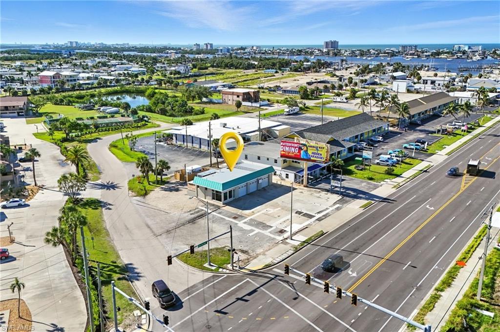 FOR SALE OR LEASE — Gateway Location!  Move-in Ready Condition!  Unmatched Exposure! This offering delivers the rare combination of move-in readiness, dominant visibility, and proven traffic flow at the front door to Fort Myers Beach. As you review the photos, it becomes immediately clear that the interior is clean, modern, and thoughtfully updated. This is not a value-add or a redevelopment play — the property is ready for immediate occupancy, allowing a new owner or tenant to open and operate without major upgrades or capital delays. The real differentiator is the location. Positioned at the signalized gateway intersection to Fort Myers Beach, this high-impact corner captures approximately 24,000 vehicles per day — placing your business directly in front of island-bound traffic at the precise point where cars slow, queue, and actively look for where to stop. This is where Fort Myers Beach traffic stacks up — and where businesses get noticed first. The updated CBS construction is purpose-built for efficiency and throughput. True drive-through circulation, dual pass-through ingress and egress, and a large on-site parking lot create a rare operational advantage: customers can pull in easily, transact quickly, and rejoin traffic toward the beach without losing momentum. That seamless flow translates directly into higher volume, repeat visits, and stronger performance. The property has been refreshed inside and out, including a new roof installed in November 2023, eliminating near-term capital concerns and reinforcing long-term confidence. Flexible interior bays and turnkey improvements allow a wide range of retail, service, or convenience-oriented uses to activate quickly, while the gateway visibility does the heavy lifting every day. This is a location businesses fight for — high exposure, easy access, and immediate usability, all at the primary entrance to Fort Myers Beach. Gateway sites like this are rare. Move-in-ready ones are rarer still!