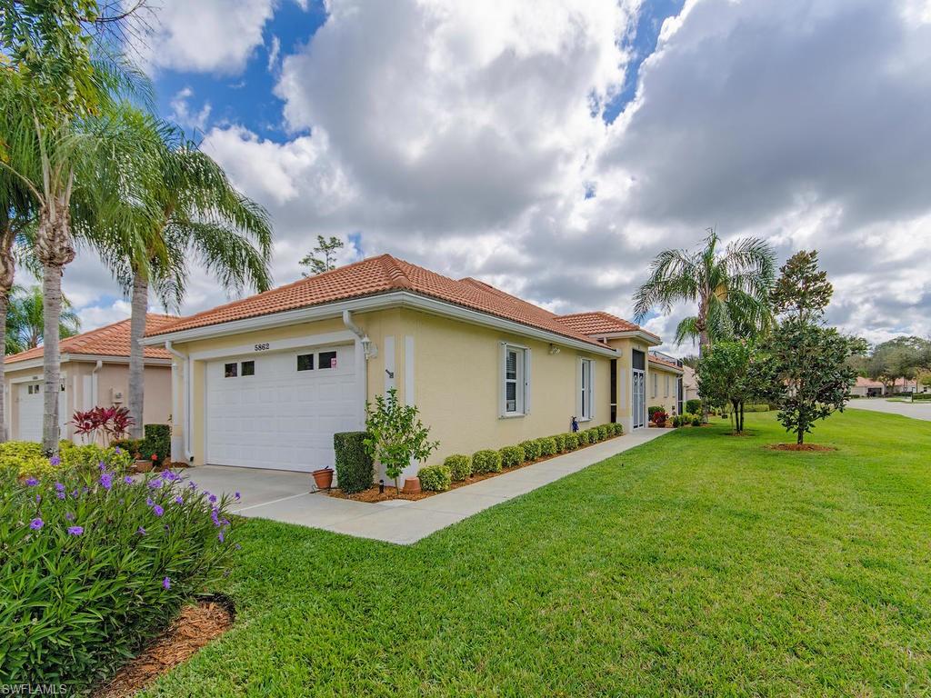 V.2705 - Stunning villa property situated on a corner lot with a lovely lake view and fantastic curb appeal. This nicely appointed and tastefully decorated villa lends a coastal feel with light flooring, volume ceilings and on trend paint palette. The large kitchen is beautifully appointed with updated cream colored cabinetry with crown molding,under mount lighting, speckled corian counter tops, eat in kitchen area as well as breakfast bar. The spacious master suite has plantation shutters, updated flooring, a large walk in closet and in suite master bath with updated lighting dual sinks and large shower. The second bedroom and guest bath have a sliding pocket door that makes a comfortable guest suite. The den is spacious and bright and also has plantation shutters.Your extended back lanai backs to the lake with Southeastern exposure and fountain view.You'll also enjoy a 2 car garage with extra storage space and large laundry room. This villa also offers both electric and accordion shutters for hurricane protection and is being sold with a 1 year 2-10 Home Warranty. A must see!