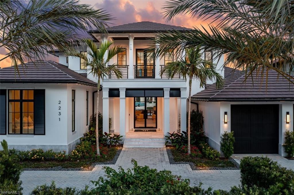 This is Naples' only neighborhood that provides walk to beach, Third Street historic district, and direct boat access. Close to a hidden beach path, and tucked away in a private section of Aqualane Shores, this custom home was beautifully designed and furnished by Broad Avenue Studios, expertly crafted by Toscana Homes, and penned by the renowned Stofft Cooney Architects, showcasing timeless elegance and meticulous attention to detail. Situated on 107' of waterfront with protected harborage on Kite Cove, the property is close to the open waters of Naples Bay with direct gulf access. Built with full concrete construction, the interior features European oak floors throughout, enhancing the warmth and sophistication of the great room that presents 10’ tall pocketing lift and slide doors to seamlessly integrate the outdoor living. The chef’s kitchen is a culinary dream, boasting a 60" Wolf range with double ovens, 72” Subzero refrigeration, and custom SOHO cabinetry covered in honed quartzite counters, and complemented by a butler’s kitchen for seamless entertaining. Modern conveniences abound, including Lutron lighting, three washer and dryer sets, tankless water heaters, and natural gas service with a 48KW whole home generator. Each en-suite bedroom is an oversize private retreat, while the study offers flexible space for work or relaxation. The outdoor area is an entertainer’s paradise, with a resort-style 40’ lap-pool and custom spa, a fully equipped outdoor kitchen, lower firepit deck, and spacious covered seating areas that overlook the serene tropical waterfront. Close to Naples’ finest restaurants and world-class shopping on 5th Avenue South and Third Street South. With both beach and boating lifestyles at hand, this is the pinnacle of refined waterfront living in Aqualane Shores.