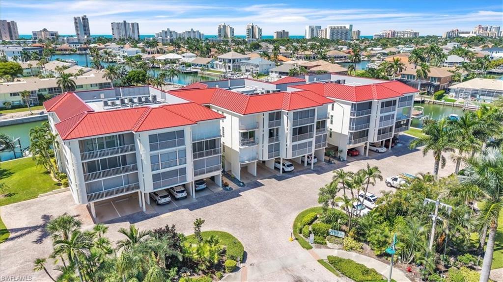 Experience Marco Island living at The Nautilus from this spacious 1,875-square-foot waterfront 2-bedroom plus den, 2.5-bath condominium featuring an assigned boat dock with direct, no-bridge Gulf access and a prime location just a short distance from South Beach. Ideal for boating enthusiasts, seasonal residents, or full-time living, this residence offers an exceptional opportunity to enjoy the island lifestyle.

Designed with a floor plan that lives like a single-family home, the interior features generous living spaces, abundant natural light, and multiple sliding glass doors leading to private balconies and a large screened lanai overlooking tropical landscaping. The split-bedroom layout provides privacy for owners and guests, while the den offers flexibility for a home office, additional guest accommodations, or a sitting area.

The kitchen offers ample cabinetry and storage and opens seamlessly to the main living and dining areas, creating a comfortable flow for everyday living and entertaining. The spacious primary suite features a walk-in closet, private bath, and direct lanai access.

Recent improvements include a brand-new A/C system installed 03/2026, while the building has also been recently painted, enhancing both appearance and long-term value. Community amenities include a waterfront pool, fitness room, renovated community room, dedicated parking space, and additional ground-floor storage.

Conveniently located near Marco Island’s white-sand beaches, shopping, dining, and waterfront activities, this condo offers a rare combination of space, boating access, location, and value in one of Southwest Florida’s most desirable coastal communities.