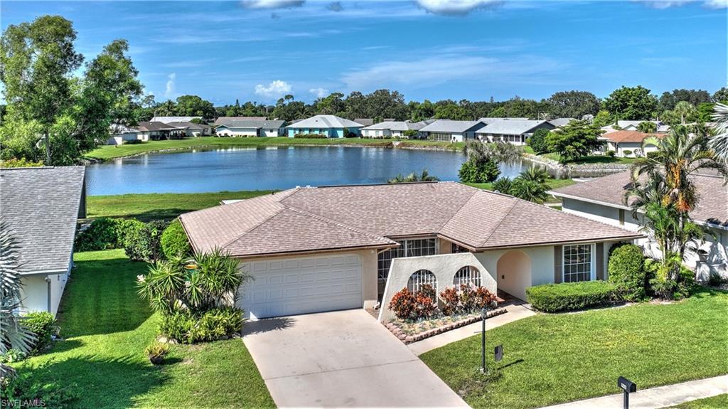 STUNNING VIEWS of the lake and golf course await the new owner in this adorable 2 bedroom 2 bath w 2 car garage! Enjoy your morning coffee on the lanai overlooking these amazing views. This popular subdivision of Riviera Colony Golf Estates is a 55+ active community with all kinds of amenities; newly renovated salt water community pool, tennis and pickleball courts, billiards and clubhouse with a variety of planned activities for the residents and more.  This property has over 1300 plus square feet with over 240 square feet of glass-enclosed lanai. The roof is a 2017, electric shutters, house wired generator, no-see-um screens just installed on the lanai brand new irrigation pump, FOSCAM security and a complete electric rewire was completed in 2017.  Lets not forget the location, location, location! This home is close to the beaches and wonderful shops and restaurants of Downtown Naples. Listings in this area don't usually last long. Make your appointment today!