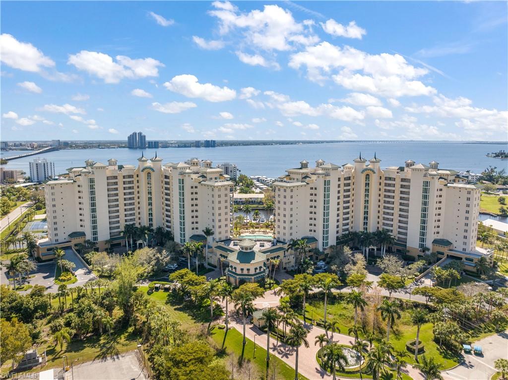 Amazing Riverfront Living–Sunrise Views from the 12th Floor! Million Dollar Views.  Wake up to panoramic sunrise views over the glistening Caloosahatchee River from this stunning 12th-floor retreat at the prestigious North Star Yacht Club. This beautifully upgraded Capricorn model showcases the very essence of Florida waterfront living — where luxury meets lifestyle, and every day feels like a vacation. Step into nearly 1,800 square feet of thoughtfully designed elegance, featuring soaring 10-foot floor-to-ceiling impact glass windows that flood the space with natural light and frame jaw-dropping vistas of the river, resort-style pool, and private marina. Whether you're sipping coffee at sunrise or enjoying a glass of wine at dusk, the southeastern exposure ensures your home is always bathed in warmth and beauty. The open-concept floorplan flows effortlessly, with diagonal tile throughout the main living areas, engineered wood flooring in the guest bedrooms, and plush carpet in the private main suite. Recent updates include: Custom motorized electric shades throughout Modern light fixtures and ceiling fans 2018 smudge-proof stainless appliances New hot water heater (2018) Fresh paint and crown molding throughout Your spacious owner’s suite is a sanctuary of comfort, complete with dual walk-in closets featuring hardwood shelving, and a spa-inspired bath with separate vanities, a soaking tub, and walk-in shower — perfect for unwinding after a day on the water. Bonus features include a rare extra storage room on the 5th floor, a private storage locker, and two first-floor covered parking spaces—a convenience few units offer. Resort-Style Amenities on the Waterfront North Star Yacht Club sits on over 12 acres of lush, manicured grounds along the riverfront, offering an unmatched array of amenities that cater to your active and social lifestyle: Expansive resort-style pool and spa Lap pool, BBQ areas, and scenic walking trails Tennis, pickleball, bocce ball, and volleyball courts Private dog park just expanded State-of-the-art fitness center and yoga studio Theater room, billiards lounge, business center, and renovated clubhouse with kitchen A vibrant community with regular social events, fitness classes, and clubs Follow the private path along the waterfront to restaurants, cafés, salons, and boutiques—all just a stroll away. Comprehensive HOA includes: property and flood insurance, building maintenance, biannual window cleaning, annual dryer vent cleaning, weekly hallway service, and full grounds upkeep—offering true peace of mind and carefree living. Structural Integrity Reserve Study Complete and reserves fully funded! Milestone Inspection Report is not due until 2032. If you've been dreaming of a sophisticated, low-maintenance lifestyle on the water — where luxury meets community and every detail is taken care of — this is your moment. Live the Waterfront Life at North Star! Your riverfront paradise awaits.