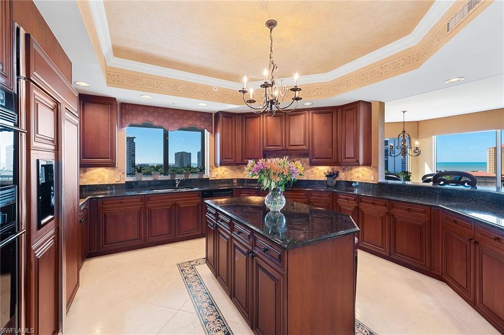 Traditional style and designer finishes with gorgeous panoramic views! This elegantly furnished 9th-floor luxury residence features all new wide plank dark walnut wood floors and polished neutral travertine marble enhancing over 4,800 square feet of living in an open floor plan layout with meticulous attention to detail including multiple dining and entertaining areas, granite countertops, a spa like master bath with a soothing jetted soaking tub, and lots of storage. Your friends and family can retreat to 3 spacious guest suites all with en suite baths. Trieste residents enjoy a geo-heated tropical pool, a well-equipped fitness room, social room, library, staffed front desk in lobby, and more. Enjoy a relaxing day at the private renovated Bay Colony Beach Club with attended beach services or work on your serve at Bay Colony Tennis Club. Trieste makes a perfect home for living an incomparable Naples lifestyle!