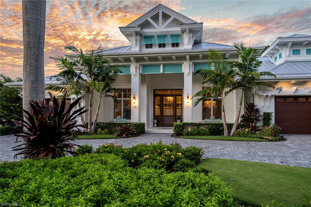 423 Spinnaker Drive is a sand dollar award winning, superior custom beach home in the Moorings. West of Crayton Road and a short walk to Moorings resident’s beach park.  Spectacular quality that was built to exacting standards and custom coastal design. The home’s single level living spreads more than 6,000 square feet under roof on an oversized lot located on a quiet street. Inside, the ceilings are a highly detailed millwork, accented in beautiful wood paneling, beams, coffers, and corbels. Wide plank Legno Bastone oak floors flow throughout the home’s great room layout. Custom made cabinetry and built ins house the finest appliances from Wolf-Subzero. A full summer kitchen leads to the expansive outdoor living areas with roll down screens and shutters, surrounded with tropical foliage. The glimmering glass tiled pool and spa with swim up underwater seating at the sun deck set the stage for the glow of fire bowls and linear fireplace at night.