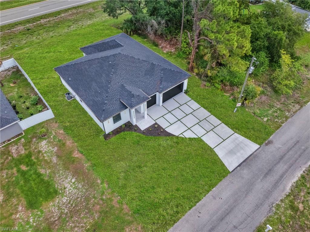 Motivated seller. Builder is offering up to $15,000 toward closing costs.  Welcome to this MASSIVE over 2,121 SQFT home.  This impressive floor plan spotlights GRAND elevations with admirable 8ft double entrance, 4 spacious bedrooms with generous Walk-In closets, 3 luxurious bathrooms HIGH ceilings with enhancing trays.  The spacious primary suite offers a spa-inspired master bathroom complete with elegant rain shower, dual vanities, and premium details throughout. 8ft sliders with dual access out to the spacious back patio, an irrigation system. It also highlights exquisite porcelain tile throughout, IMPACT windows & doors.  The rewarding kitchen features an inviting breakfast bar, soft close shaker cabinets, high gloss kitchen, STAINLESS STEEL appliances, and a pantry.  Custom mirrors, laundry under air and a rare 3 car garage, Greenbelt and NOT in a flood zone. Schedule your showing today!