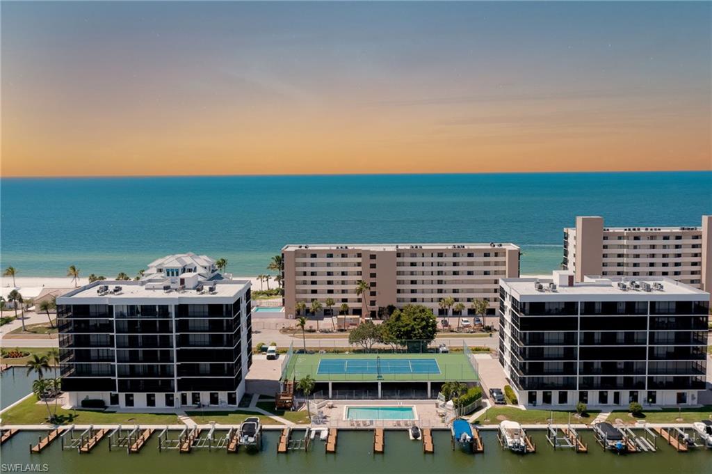 Immaculate 5TH FLOOR CORNER, END unit remodeled and beautifully decorated. GULF & BAY VIEWS from the 5th floor with wrap-around lanais for endless Naples sunrises and sunsets. Open floorplan with breathtaking bay-side views from all rooms. New AC 2024. Vanderbilt Bay has 3 units per floor for maximum privacy. Private bay-side pool, tennis court /pickleball, and onsite docks for lease or purchase upon availability. Walk across the street to your deeded access to Vanderbilt Beach for a morning jog and meditation. Enjoy an evening stroll, and relax at fine dining at La Playa Beach Resort. Less than a mile drive or bike to Mercato for boutique shops and dining, Whole Foods, and the Ritz-Carlton. Enjoy this spacious unit as a perfect winter getaway, dream home, or a terrific rental income opportunity. Come see for yourself and make this your moment to own in Naples, Fl