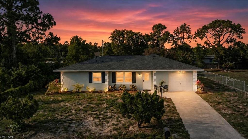 Welcome to this completely renovated 3-bedroom, 2-bathroom 1496 sqft Lehigh Acres retreat where every inch has been thoughtfully redone. Step inside to a sun-soaked open-concept floor plan with brand-new luxury vinyl flooring, fresh paint, recessed LED lighting on dimmers, and modern matte fixtures throughout.

The chef's kitchen stuns with shaker cabinets, quartz countertops, a sleek glass backsplash, floating wood shelves, and a brand-new stainless appliance package. Both bathrooms have been fully redone — the primary ensuite features a floor-to-ceiling luxury tile walk-in shower with sliding glass door ; the guest bath offers a luxury-tiled soaking tub. The spacious primary bedroom plus two additional bedrooms give you room to grow.

Outside, your massive screened lanai overlooks a fenced 10,880 SF backyard with mature mango trees and a stone firepit w/ plenty of space for various activities. NEW roof, NEW water heater, NEW windows, NEW landscaping. Attached 1-car garage, central A/C, well & septic.

Walkable to local amenities and minutes to downtown Fort Myers. True turnkey — just bring your suitcase. Schedule your private tour today.

NOTE : Black shutters to be added on both sides of the 2 front windows