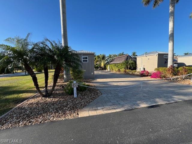 What a great fully paved back in Lot on Meadow Beauty Trail which is the newest section of the resort.  This lot comes with professionally installed irrigation throughout a variety of beautifully landscaped plants and trees.  The rear of the lot features a Yardistry 15 x 11‘ Gazebo Structure complete with a side bar, two stools and a lighted fan.  Under the structure enjoy an additional three seat six cushion outdoor seating.  Stay warm on the chilly evenings with the patio Renaissance  Propane fire pit.  You will love this finished 8 x 15‘ Amazon shed with gray plank flooring, a shower, toilet, sink, overhead cabinet and on demand hot water heater.  Also included in the shed is a Toshiba wall air conditioner and an LG stackable washer and dryer dryer which has the Sensor dryer and the washer has a direct drive. You will love there is extra storage above the bathroom.  Enjoy this very large open green space in the rear and  another open grassy common area to the left in which the HOA takes care of all the grass cutting.  More features of your HOA fees are the sewer, water, fiber optic internet and digital television.  
Call for more info and your private tour.