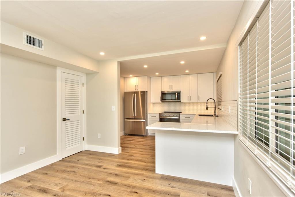 COMPLETELY RENOVATED CONDO IN A EXCLUSIVE NAPLES LOCATION! This 2 bedroom/2 bathroom 1st Floor condo has a beautiful lake view! Everything is brand new including the electrical and fire upgrade to 2021 code. ALL BRAND NEW BATHROOMS, KITCHEN, APPLIANCES, FLOORS, LED LIGHTS, FANS, CLOSETS, WATER HEATHER, BLINDS, IMPACT WINDOWS AND DOORS and more. Swan Lake Club is a PET Friendly community and has been gone to a total renovation including the pool and parking areas. Walk to VENETIAN VILLAGE and bike to the PRIVATE PARK SHORE BEACH anytime!