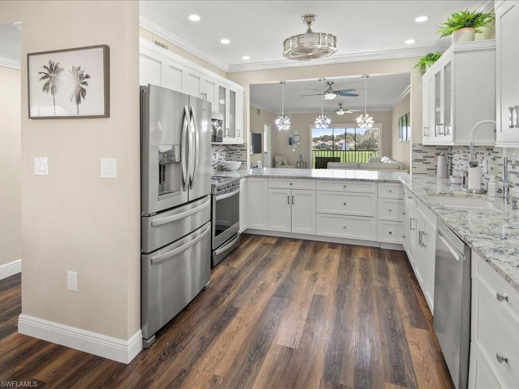 Sharp and stylish describes this move-in ready condo.  It comes furnished and features panoramic golf views of the 15th fairway in addition to a great layout and beautiful finishes throughout.  Unique floor plan with TWO screened lanais (in the front and back) which allows for wonderful cross ventilation in the cooler months.  The LARGE kitchen is perfect for entertaining and has plenty of counter, cabinet and pantry space as well as premium stainless-steel appliances.   Recent improvements this year include a new HVAC, water heater, interior paint, lanai screening and furnishings.  There is also covered parking (carport space,) an extra storage area as well as storm shutters.  Prime location walking distance to Crossroads Shopping Center and easy access to dining, shops, golf, beaches, downtown, healthcare, I-75 plus Vineyards Community Park, elementary school, etc.  Optional memberships to Vineyards Country Club available offering world-class amenities including a championship golf course, newly renovated clubhouse, state of-the-art wellness center with fitness center and spa, tennis, racquet ball and more all designed to complement the perfect Naples lifestyle!
