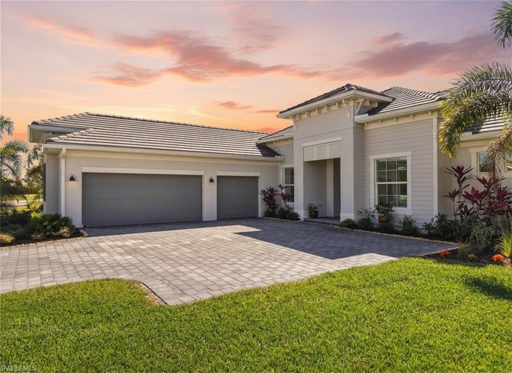 Turnkey living, endless sunsets and bundled golf await at this 2023 Napoli II estate home in the National Golf & Country Club at Ave Maria.  Offered fully furnished, it even comes with a brand-new golf cart — all you need are your clubs!  The split-bedroom floor plan provides 2,395 sqft with three bedrooms, a den and 2.5 baths.  An open-concept kitchen with over-sized island anchors the home and is equipped with high-end appliances and three refrigerators for entertaining.  A formal dining area and breakfast nook flow into the great room and out onto a screened lanai.

Set on a quiet cul-de-sac overlooking the 16th fairway, the residence enjoys southwest exposure and is just seconds from the Pro Shop.  The lanai hosts a heated pool and spa, an electric storm screen and a Blackstone and gas grill.  The owner’s suite features a huge walk-in closet and a spa-like bath with separate soaking tub and shower.  Plank tile floors, neutral palate, laundry room with sink, and cabana bath add comfort and practicality, while a surge protector on the electric panel safeguards your appliances & electronics.

The oversized three-car garage has space for your vehicles and the included golf cart.  Outside, pavered drives and manicured landscaping complete the curb appeal.  As part of the National Golf & Country Club, homeowners enjoy a Gordon Lewis–designed 18-hole championship golf course, with deeded membership included.  The resort campus offers a zero-entry pool, state-of-the-art fitness center with sauna, full-service spa, tennis and pickleball courts, and a clubhouse with indoor and outdoor dining.  Nearby Naples and the town center of Ave Maria expand your dining and shopping options.