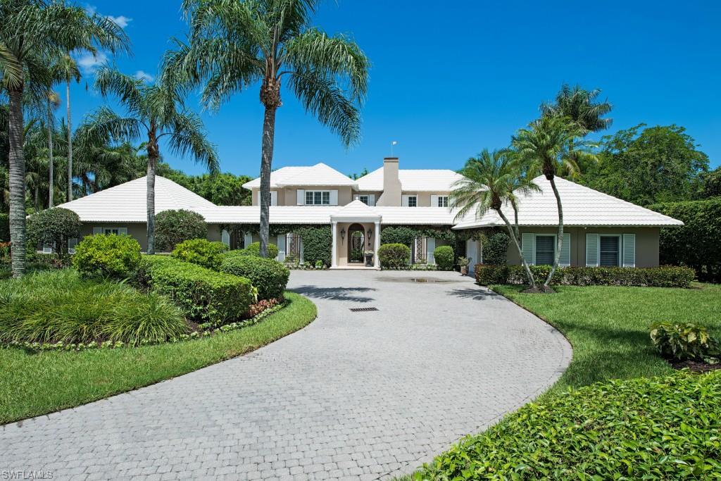H.9507 - This magnificent Bermuda styled Port Royal home sits on a lot and a half with lush tropical environs.  Warm and inviting throughout its 5,528 Sq.Ft. of living space with an open, flowing floor plan.  Features include beautiful marble and wood flooring, updated gourmet kitchen, multiple marble rimmed gas fireplaces, extensive millwork, coffered ceilings, large study with gorgeous built-ins, pool bath and more.  The gourmet kitchen was remodeled by BCB with oak flooring, top-of-the line appliances, wine cooler, wood topped island with warming tray and 2nd sink, 2nd Island topped with soapstone, 6-burner range and double wall oven.  Home also has guest cabana with bed/bath, kitchen, living room and pool walk-out.  This home has great entertainment space with long 42’ pool, raised pavilion and lush landscaping.  Located within walking distance to the beach and the prestigious Port Royal club.