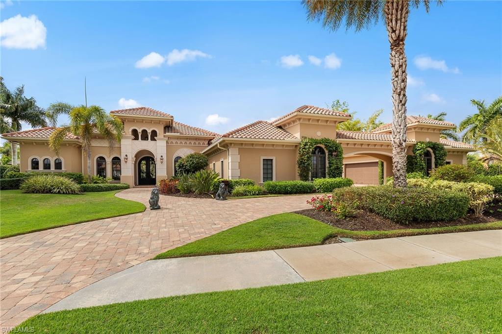 One or more photo(s) has been virtually staged, AI generated or rendered. See photos 9 and 28. In the gated community of Quail West Golf and Country Club, this transitional-style residence built in 2015 offers 3,270 square feet of living space on a spacious lot with partial golf course views and southwestern exposure. The property includes four bedrooms, four full baths and one half bath, designed to support everyday living and entertaining. The outdoor living environment features a screened lanai with a pool and spa, outdoor kitchen, fire pit, covered dining area and an additional outdoor living room space. The spacious backyard is framed by mature trees, creating privacy while maintaining select views of the golf course. Inside, the kitchen includes a breakfast bar and opens to the main living areas. Flooring throughout the residence includes tumbled porcelain tile and carpet. The primary suite includes dual closets and a bath with a soaking tub. Additional features include a four-car garage and a whole-house generator. Quail West residents enjoy access to an amenity-rich private club offering golf, tennis, pickleball, fitness facilities, a full-service spa, bocce and dining venues. A transferable social membership is available at closing.