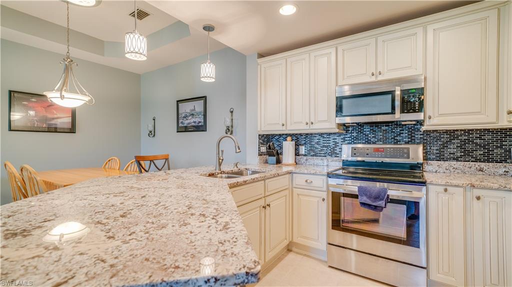 MASSIVE PRICE ADJUSTMENT!!! Immaculately maintained 2 bed, 2 bath condo with a garage and ample room for a home office - PRICED TO SELL! Enter the community via gated access. Enter the 3rd floor home via an elevator and a secured, lovely foyer. The updated kitchen has light cabinetry with soft close drawers & doors, a large single tiered granite counter top, a tiled backsplash, new(er) LG stainless appliances, new pendant lighting, and beautiful fixtures; great for light dining or entertaining. The dining room easily seats 6. This bright and cheerful home features tile and wood flooring, fresh paint, and abundant Florida sunshine! Enjoy coffee and/or cocktails as you sit on the screened lanai overlooking a well manicured and calming palm treed courtyard. The oversized master suite has a walk-in closet, dual sinks, quality cabinetry, and a stand alone shower. The generous 2nd bedroom is across the hall from the well appointed 2nd bath. Private laundry? YES; with new(er) Maytag washer and dryer and additional storage space. Enjoy the resort style pool, full sized gym, pickle ball, pet park, picnic areas, and playground. $3,500 community assessment PAID IN FULL! | AC NEW 5/2023!