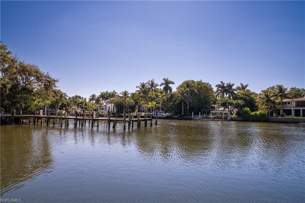 Tucked in the private enclave of Little Harbour and on navigable water, this meticulously maintained estate is a classic gem.  Rich in detail and character, this traditional British West Indies offers 4 en-suite bedrooms, spacious office, quiet media room and a tropical outdoor oasis.  Floor to ceiling glass windows and doors throughout allow natural southern light to stream in and brings the outdoor in with views of the peaceful, trellised courtyard and resort like pool with sun shelf.  As entertainer’s delight, the backyard is terraced with epay decking down to the dock and includes a separate bar area with rolldown screens to enjoy while relaxing by the pool.  A true chef’s kitchen, residents will love the well-designed layout, Viking Double oven range with griddle, large island and separate bar area with wine tower and Miele coffee maker, all with quick access to the formal dining area. Complete with a Crestron system, built in outdoor grill and fireplace, 3 car garage, boat and jet ski lift and all with quick access to the gulf and beach, this Little Harbour estate is the ideal Naples home. Although a wait list, this home is eligible for Associate Port Royal club membership.