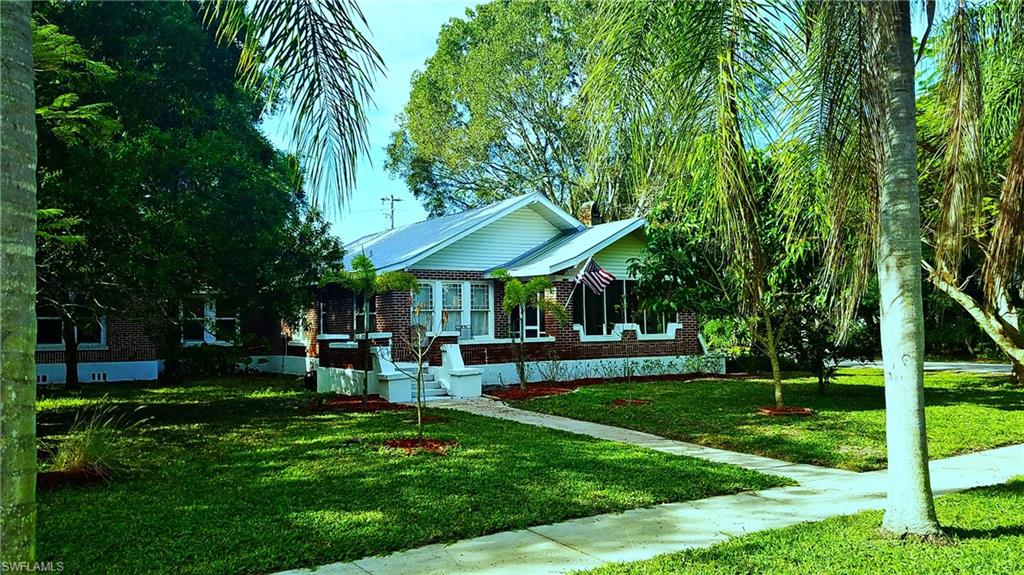 NEW PRICE! SELLER WILL ASSIST WITH CLOSING COSTS. **NO FLOOD INSURANCE REQUIRED** Large 1/3 acre corner lot & huge garage/carport combination are just the beginning of the features of this 1925 built, red brick expanded craftsman style home. Quiet neighborhood off McGregor w/ tree lined streets & sidewalks, 5 minutes to downtown Fort Myers! Updated guest bath & completely updated kitchen 2019, combining functionality w/ traditional design. Metal roof on house & garage in 2003. Transferable termite bond in place and Wind mitigation work report is available. Irrigation well and sprinkler system.  Heartwood pine flooring in many living areas & wood burning fireplace. Large addition features original brick for the exterior, plenty of living area and a master suite & guest bedroom. Outside is a large screened front porch and raised open patio for relaxing or entertaining.  Rear area includes brick paver patio in shade of large 100 yr old oak tree. 28' deep & 25' wide garage-plenty of space for 2 vehicles and storage, PLUS a 20 x 25 covered carport and large driveway. Walk to historic district, Caloosahatchee River & nearby parks. Historic beauty, space and location--a great combination!