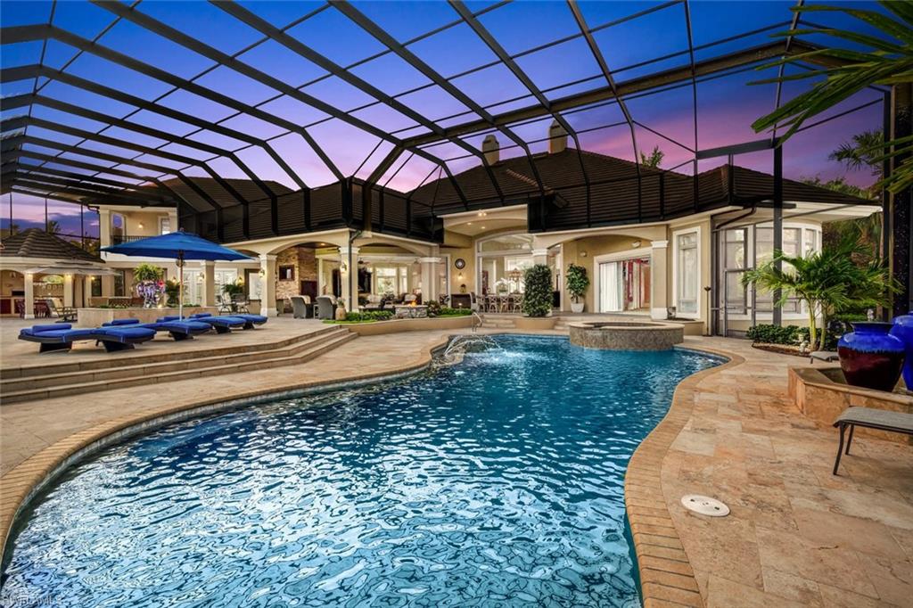 BRAND NEW ROOF! STUNNING Estate home on one of the BEST lots in the exclusive Baywoods neighborhood of Bonita Bay! Beyond the lushly landscaped circular driveway, double glass doors & open foyer welcomes guests w/a gorgeous view of the lake & golf course. With 7,106 sq. ft. under air, the palatial Harwick Homes-built former model is the perfect residence for the active family or for those who wish to entertain on an impressive scale. Defining classic splendor & luxury, this home offers a spacious owner’s wing with his/hers closets & toilets, jetted tub, washer/dryer & direct pool access. 2 custom his/hers offices, 4 en-suite bedrooms & formal/casual dining. Professional kitchen w/top of the line appliances w/2 or more of everything is perfect for large-scale meal preparation w/breakfast area & walk-in pantry + 500-bottle wine room! ABUNDANT light, custom moldings, coffered/tray ceilings, South Exposure & exquisite finishes! EXPANSIVE screened lanai w/wood burning pizza oven, outdoor kitchen, fire pit, resort-style swimming pool & spa overlooking the lake & golf course. 5 car garage (3 w/AC), fenced dog run & SO MUCH MORE! Don't miss this rare opportunity to acquire this dream home!
