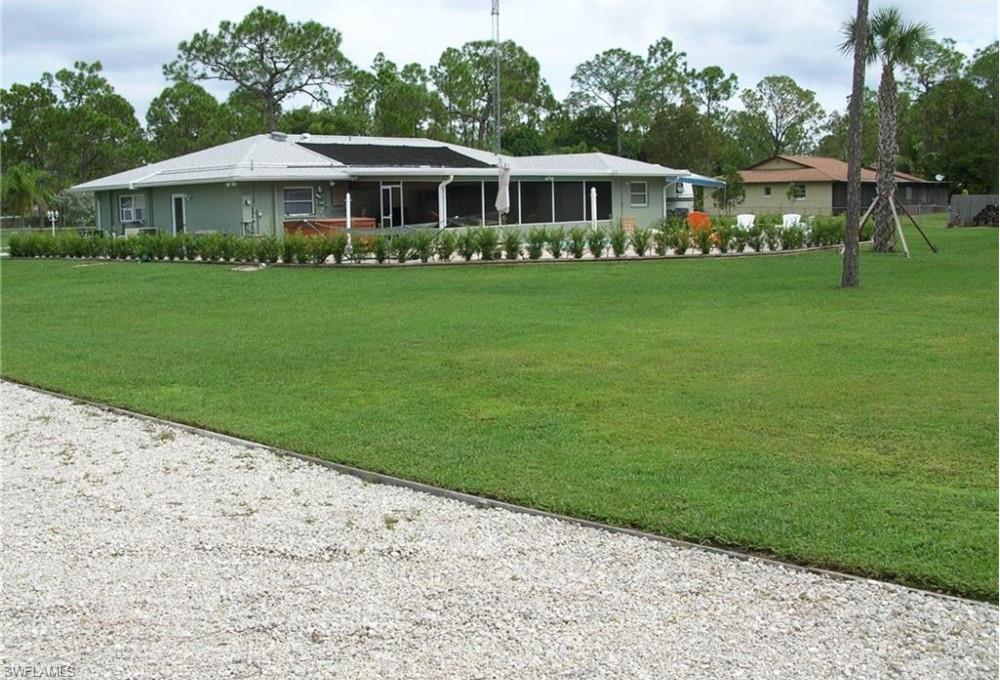 ("ONLY" ASKING PRICE OFFERS WILL BE ACCEPTED)   LET YOUR IMAGINATIONS RUN WILD! BUILD A HUGE WORKSHOP! BUILD A HUGE POOL WITH A 1,000 FOOT LAZY RIVER FOR THE GRAND KIDS! YOUR IMAGINATIONS ARE ENDLESS ON THIS PROPERTY! Very slow and quiet street with great far away neighbors. Just off the beaten path with civility right around the corner. Gravel driveway 60 x 230 and newer 4 car paver
driveway in front. Air conditioned 2 car (580sq ft) garage! 480sq ft screened and tiled back lanai with structural roof with new 15ft wide pocket sliding glass doors. 270sq ft front screened lanai with "Elite Roof". 11 ceiling fans throughout (7 with remote control) All furniture, lawn tractor, lawn equipment, heavy duty work bench with dual grinder and vise, generator with house generator hook up, Weber gas grill etc is included. Brand new A/C and heat inside and out with 10yr warranty. Brand new 50gal hot water heater. Washer/dryer 2yrs old. New garage door opener with new door rollers and full size pull down garage door screen with sliding door. All tile floors (no carpet) Exterior security lighting. All "Hip" style roof with roof truss strapped to concrete walls This property is being sold "AS IS"