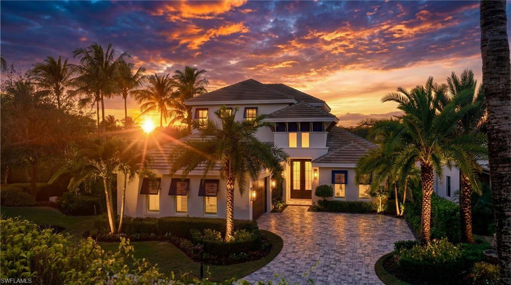 Welcome to an extraordinary waterfront retreat in Miromar Lakes Beach & Golf Club, where timeless elegance meets effortless resort-style living. Ideally located near the renowned Arthur Hills Signature Championship Golf Course, this custom estate by Arthur Rutenberg Homes offers an exceptional blend of luxury, comfort, and breathtaking surroundings.

Perfectly positioned with coveted western exposure, the home showcases spectacular sunset views across the water. Spanning two beautifully designed levels, the residence features four bedrooms, five-and-a-half baths, and inviting spaces created for both everyday living and entertaining.

The heart of the home is an expansive open-concept living area that flows seamlessly from the dining room to the chef’s kitchen, complete with a walk-in pantry, reverse osmosis water system, and easy access to the outdoor living spaces. Step outside to your private resort-inspired lanai, featuring a sparkling pool and spa, stacked-stone fireplace, and a fully equipped outdoor kitchen and bar with a pizza oven and Evo teppanyaki grill. A dedicated pool bath adds convenience for outdoor gatherings.

Inside, sophisticated finishes, designer lighting, Control4 smart home technology, and integrated surround sound create an atmosphere of comfort and refinement. The luxurious primary suite offers a peaceful retreat with a spa-like bath, while a flexible first-floor guest suite or office adapts to your lifestyle.

Upstairs, two spacious guest suites with private baths provide comfort and privacy, while a welcoming lounge with a wet bar and refrigerator is perfect for relaxing with family and friends.

Additional highlights include an oversized air-conditioned two-car garage with epoxy flooring and numerous premium upgrades throughout. Beyond the home, residents enjoy the unparalleled amenities of Miromar Lakes, including a 700-acre freshwater lake for boating and watersports, a private white-sand beach, championship golf, tennis, pickleball, a full-service marina, fitness center, spa, waterfront dining, and a vibrant social scene.

Offering an exceptional combination of waterfront beauty, luxury, and world-class amenities, this remarkable estate presents a rare opportunity to experience the very best of Miromar Lakes living.