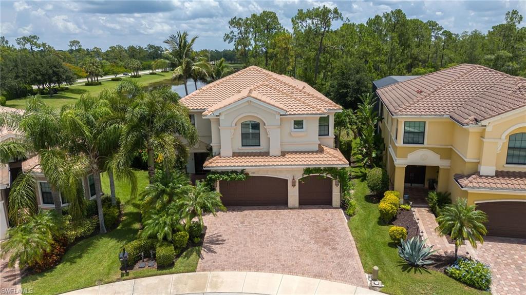 This exceptional Shiraz floor plan residence in the prestigious Riverstone community showcases refined living on a premium .27-acre long-lake lot with coveted northern rear exposure. Offering 6 bedrooms and 5 baths, the home is richly appointed with Italian porcelain tile, hand-scraped wood flooring, upgraded carpeting, and custom maple cabinetry. The gourmet kitchen features Thermador and Miele appliances, a built-in espresso maker, and a 45-bottle wine cooler, perfect for the culinary enthusiast. Additional luxury upgrades include impact-resistant windows and doors, a 500-gallon buried propane tank, updated Carrier A/C (2023), and an industrial Rheem 80-gallon water heater (2026). The outdoor oasis boasts a custom Nassau pool and spa with color-changing lighting, newer pool pump (2025), Zingas motorized exterior shades (2025), and a built-in Artisan outdoor kitchen (2025) surrounded by lush, professionally designed landscaping. A 3-car epoxy-coated garage with custom cabinetry, whole-home audio speakers, custom closets, office built-ins (2021) and whole house Kinetico Water Filtration System (2020) further elevate the home’s sophistication. Located in Riverstone—one of Naples’ premier gated communities—residents enjoy a resort-style clubhouse, fitness center, lap and lagoon pools, tennis, pickleball, indoor/outdoor basketball, and a vibrant social calendar. A rare opportunity to own a highly upgraded luxury home with serene lake views in an amenity-rich Naples community.