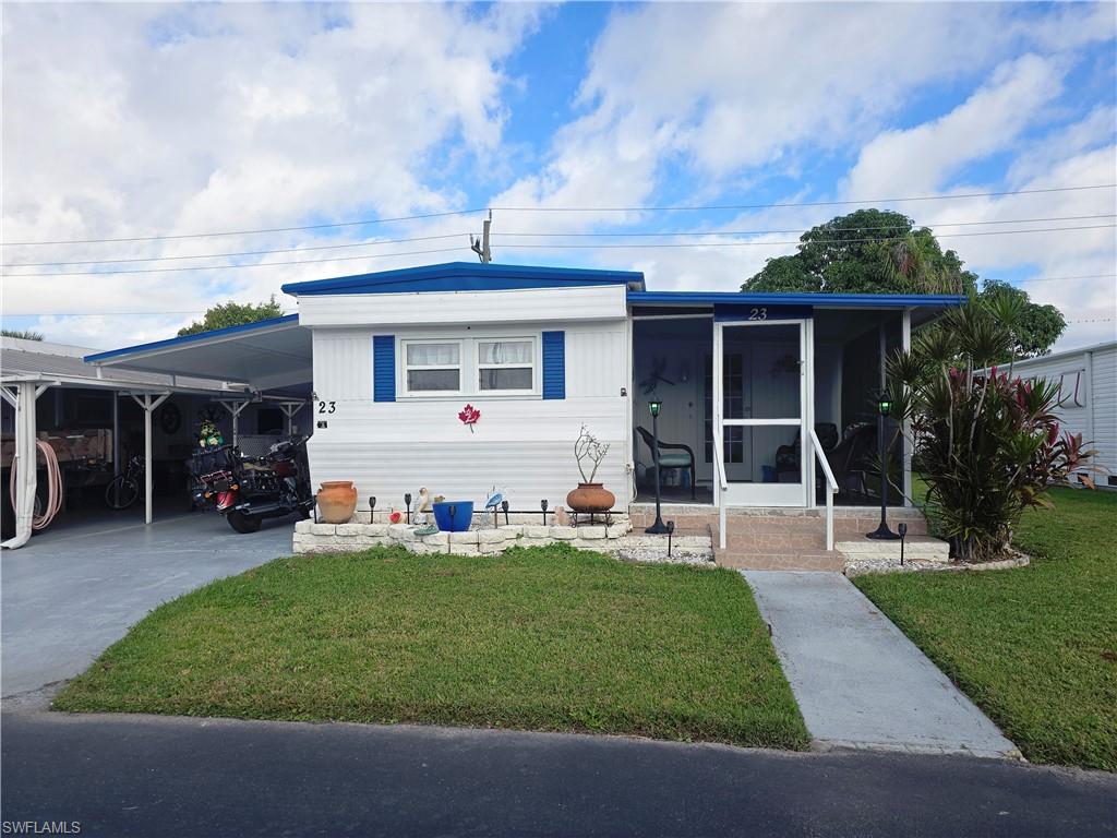 Welcome to Enchanting Acres Mobile Home Park. 23 Enchanting Blvd, is a 2 bedroom 2 bathroom mobile home with a Florida room, front screened-in covered lanai, and attached shed that houses the washer and dryer, it is also used as a workshop. As a resident of Enchanting Acres, you'll enjoy an active lifestyle with community amenities including a pool, shuffleboard, a clubhouse with a resident kitchen, a billiards room, and a library. Water, sewer, trash, lawn care, and the use of these amenities are included in the low monthly fees. Located in a prime spot, this home is just minutes from Sugden Park, Naples beaches, and Downtown Naples. The vibrant Bayshore Art’s District and various shopping, dining, and entertainment options—like Publix, planet fitness, restaurants —are conveniently across the street. This home is perfect for a seasonal getaway, full-time residence, or a second home. Note: Pets are not allowed, and ownership is Co-Op.