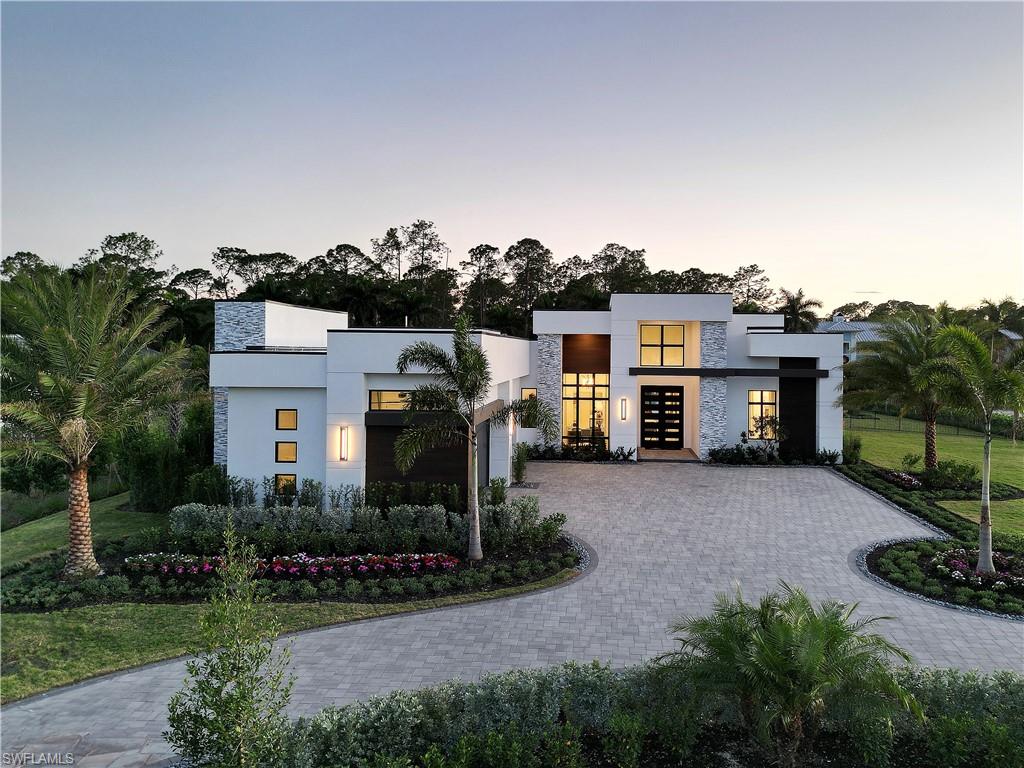 One or more photo(s) has been virtually staged, AI generated or rendered.  DESIGNER FURNISHED AND MOVE-IN READY HOME AVAILABLE NOW! Seagate Development Group and Theory Design present the professionally designed and furnished Burrata Custom Home in Silver Oak, one of Seagate’s newest, luxury communities in Naples. This custom home is a collaboration between Seagate Development Group and Theory Design with Architecture by RG Designs, and custom landscape & hardscape design by Outside Productions. Silver Oak, developed by Seagate Development Group, offers exclusive living on 10 expansive Estate homesites, each spanning 1.25 acres. With no homeowner's association, residents have the freedom to customize their homes and enjoy a superior standard of living. Enjoy a mid-century modern design with natural finishes, with Baltic Ash wood floors and cove lit reverse soffit ceiling details throughout. The Burrata model features four bedrooms, a study, four full and two half baths, and an oversized four-car garage. The spacious outdoor living area is accentuated with a private putting green, fire pit, oversized pool with sun shelf and spa, and plenty of yard space. The outdoor living area also features electric roll down screens, tongue and groove stained ceiling, outdoor kitchen, stone fireplace, pool bath and lush landscaping. The gourmet kitchen includes two tone stacked cabinetry, with lit glass cabinets, backsplash, under cabinet lighting, island with waterfall countertop, paneled Sub Zero/Wolf appliance package, walk-in pantry, oversized window providing plenty of natural lighting. The dining area includes a bar with an ice maker and a full height wine refrigerator and zero corner pocket sliding glass door. The master suite features a sitting area with glass door leading to the covered lanai. The master bathroom features marble floors and comes equipped with Kohler plumbing fixtures including 2 private water closets, dual vanities, soaking tub and a spacious shower with 3 showerheads. Additional luxury features include 9.5” Baltic Ash wood floor throughout, custom built-in closets, 1 ¾” solid interior doors, Emtek door hardware, linear HVAC diffusers in common areas, level 5 drywall, double pane Andersen impact windows & doors, Control4 home automation system, sound system, spray foam insulation, custom iron front door, natural gas, lush landscaping, and interior designer selected custom light fixtures and furnishings.