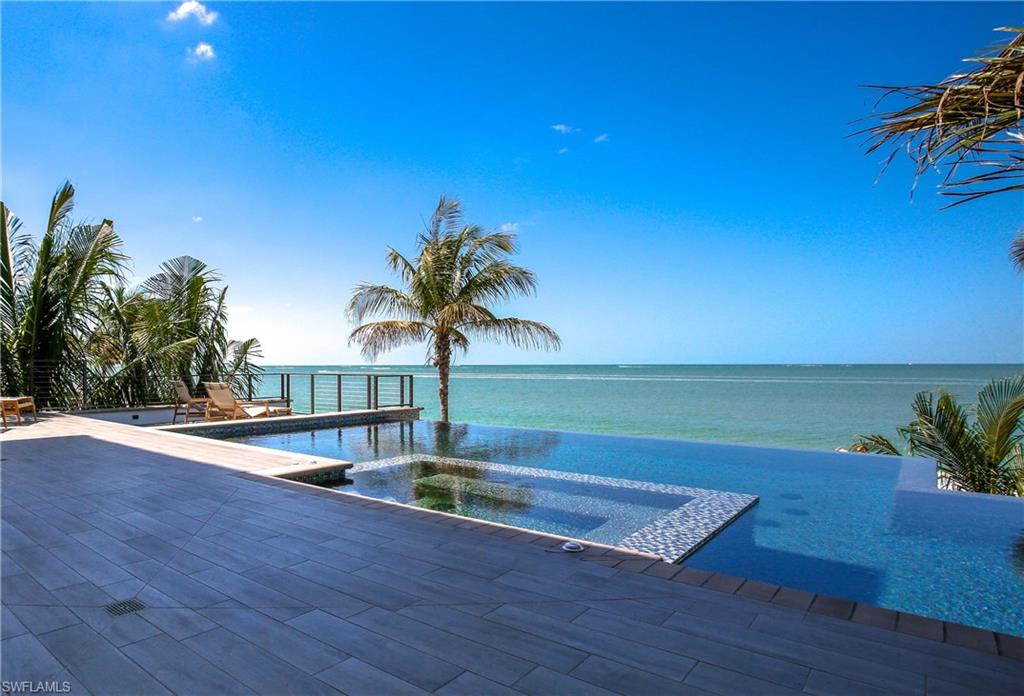 Brand new direct beachfront home by Windover Development. This is Windover's largest beachfront home to date with the most outdoor living space and the highest quality finishes yet. This state-of-the-art 2016-built home boasts only the finest craftsmanship from its concrete block construction and all hurricane impact doors/windows to its Crestron home automation system, private elevator, oak floors, intricate ceiling accent details, and quartz/granite countertops throughout. Impeccably-furnished/decorated by Collins & Dupont Design Group.  Main living level features a generous open floor plan with gourmet chef’s kitchen with all Thermador Professional appliances, wet bar and adjacent wine cellar, and spacious living and dining rooms all focused around the endless beach views. Living room flows seamlessly via fully-pocketing sliders to the elevated outdoor deck with dramatic infinity edge pool and spa. This spacious deck also includes a summer kitchen with built-in gas grill, pool bath, and many dining, entertainment, and seating areas. Luxurious master suite includes a dramatic picture window and balcony overlooking the ocean, spa-like bath, and adjacent morning bar.