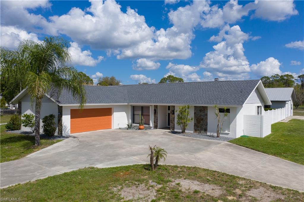 This home really does have it all:  Gorgeous home on 1.42 acres with attached double garage PLUS huge detached garage can fit 4+ cars (10 ft high door), 2 stall barn with pastures, pool, tiki, fireplace and the list goes on.  This beautiful home was just updated - stunning eat-in kitchen with new cabinetry, quartz counters, stainless steel appliances, and beautiful finishes including shiplap wall, striking bamboo flooring t/o except guest bedrooms,  gorgeous updated master bath with tiled shower, double sinks, and large walk in closet.  Decent size guest bedrooms with new carpet, nice open great room with fireplace, den/office with french doors, large inside laundry with extra storage and pantry closets, nice screened lanai, accordion shutters on every window, fiberglass, tiki hut, privacy fence by pool area, 2 stall barn -just perfect for this property.  Enormous detached garage with two overhead doors 10 ft and 8 ft; new roof 2021, attached double garage has tiled floors.  This property is amazing with so much to offer!