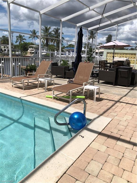 Rare opportunity to own a direct Gulf access, first floor condo. A large heated pool. slip space, turn key furnished, lovely tropical decor, granite countertops, light colored ceramic tiled floors throughout. Community laundry on each floor.  Additional storage closest. Condo building has had excellent management with a new metal roof, railings, light fixtures, pool refinished and so much more.  Only 10 units in building share large screened pool/lanai enclosure.  Walk to local pubs, restaurants and marina.  High end seafood shop next door. Wonderful sunsets!