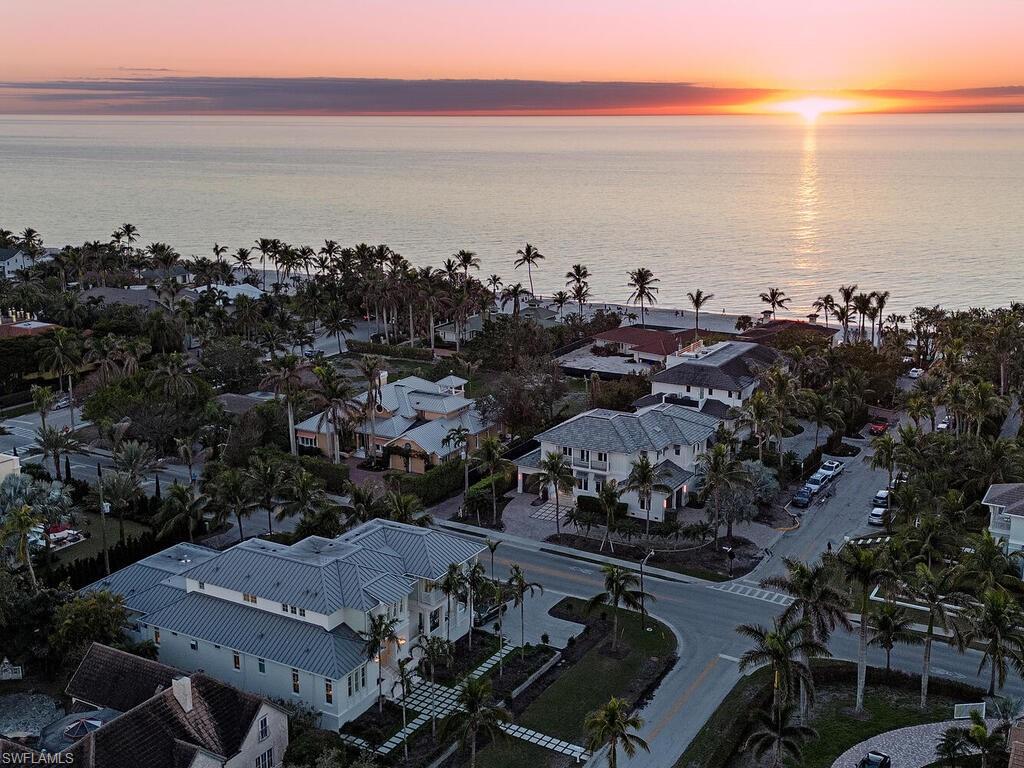 H12371- Showcasing a perfect marriage of rustic elements, bold colors, and coastal design – this iconic Home & Design featured residence is located just steps to the sugar sand coastline and one block to 5th Avenue South.