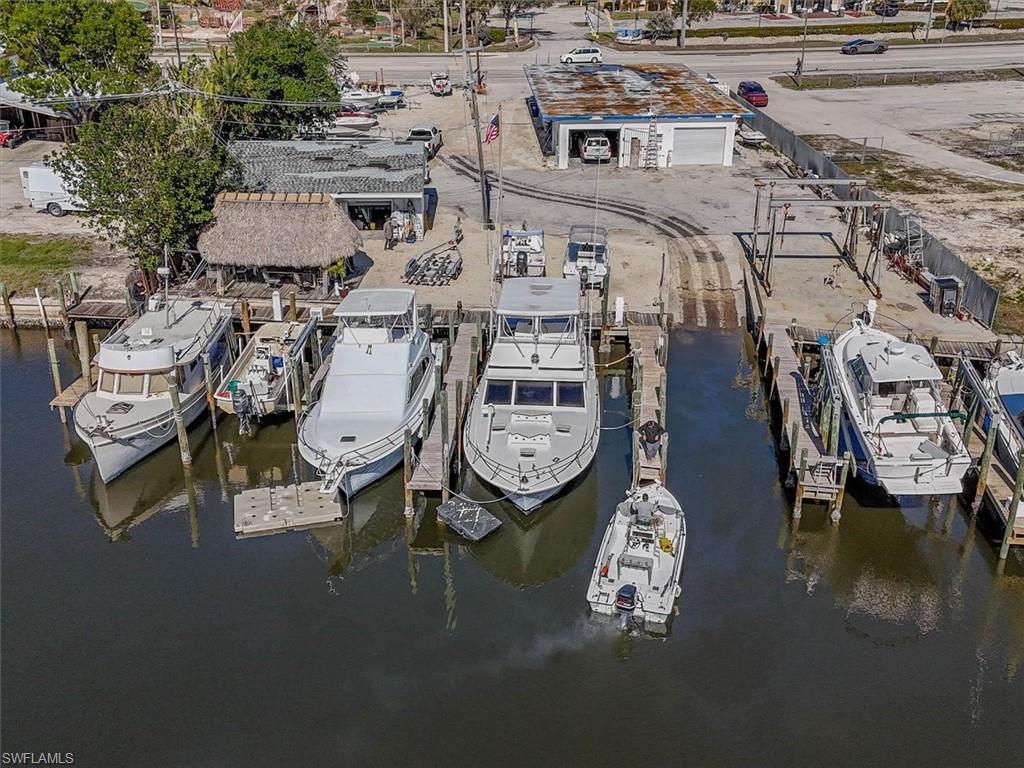 REDUCED 1 MILLON MAKE ME AN OFFER!!! SELLER WANTS TO SELL NOW!!! Possibilities are endless for this commercial property. This waterfront property has been in use as a marina including sales and repair for 25+ years, has six slips as rental income, a private boat ramp (very rare), two boat lifts 12k & 16k and direct access to the Gulf of Mexico. potential for tons more boat storage rack system. The main building facing San Carlos Blvd. has two REATIL units (approx. 1,600 sq. Ft. +/- each), both have office and retail up front with warehouse space towards the rear and currently being used as a boat sales office and retail store. Roof was replaced in 2012. The second building is approximately 690 square feet with two overhead doors (front and rear of the structure) bathroom and custom-built tiki hut that overlooks the waterway. With the Live Local Act, this property could be used as multi-family residence space as well. Allowing a potentially higher density for construction.