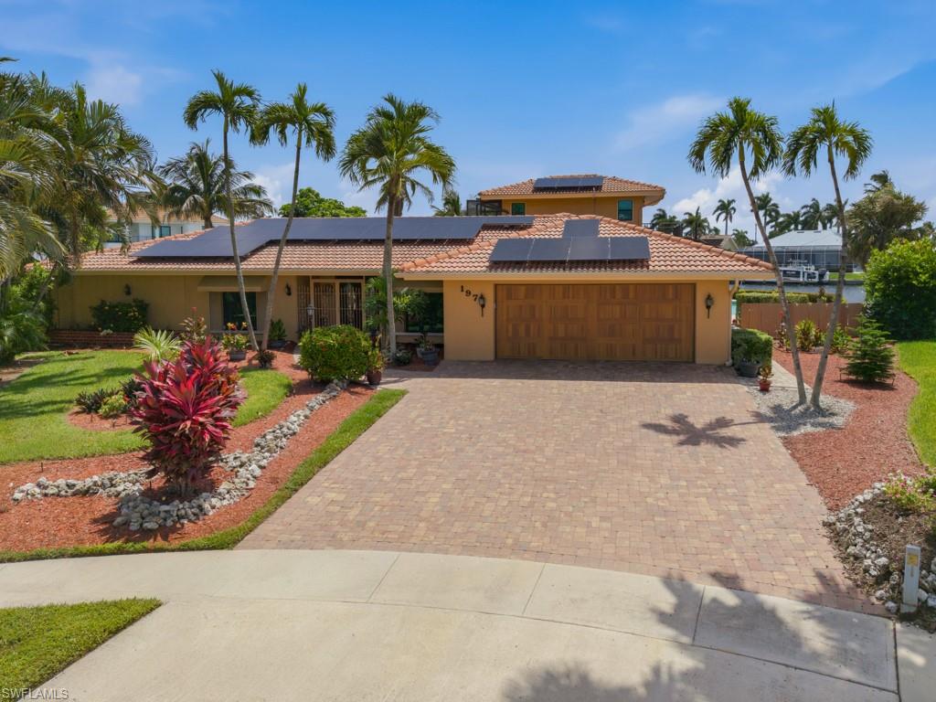 Spacious water indirect residence on a premier tip lot offering .33 acres, 193' of seawall & over 3,028 sf, providing abundant indoor and outdoor living space to enjoy the Marco Island lifestyle.
Designed for comfortable living and entertaining, the home offers both a formal living room & a separate family room, along with 3 bedrooms & 3 baths. The primary suite features a large walk-in closet with a window, a spacious shower, and plenty of privacy. Two guest suites provide comfortable accommodations for family and visitors, while a convenient pool bath serves the outdoor living area. A unique 2nd-floor retreat, accessed by a circular staircase from the pool area, functions as a 2nd family room with private balconies overlooking the water. This space could serve as a home office, fitness or media room, or add a closet to create a potential 4th bedroom. Several improvements include impact-resistant windows & doors installed in 2019, roof replacement in 2006, and solar panels for enhanced energy efficiency. Outside, enjoy the waterfront setting from the pool area, perfectly positioned on the south side of the property for excellent sun exposure throughout the day. A private dock and extensive seawall provide exceptional boating access, with a quick ride to the Marco River and beyond.