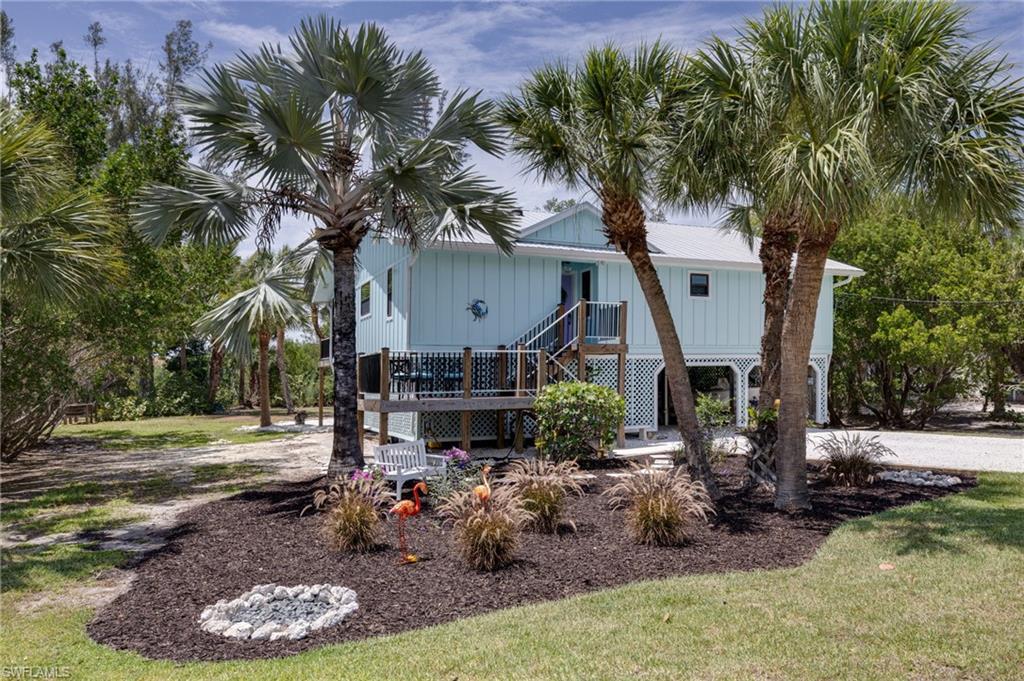 Situated on nearly one half acre in the highly desirable east end of Sanibel, this stunningly renovated home boasts natural landscaping with sunset views across the river basin.  Just a two block walk to the beach and one home from the island bike path, you're literally in the midst of wonderful island life.  This elevated home with 2022 metal roof and impact doors and windows gives peace of mind as no flooding or wind damage was sustained in the living areas of the home.  New Hardie board siding and trim, all new Trex composite on every deck, dock and horizontal outdoor surface, new gutters and new fascia round out the external upgrades to this property.  All ductwork was replaced in 2021 and the AC was new in 2022.  Inside are beautifully designed new baths and kitchen, new solid wood doors, matching custom built-in banquette seating and storage and Schluter system underlayment with Italian porcelain tile throughout.  Unique, curated features including an antique "general store" counter as the kitchen island base, and custom Turkish pierced metal lamps overhead add to the incredible island charm.  Plenty of room for a pool as well!  Call for a private showing today....