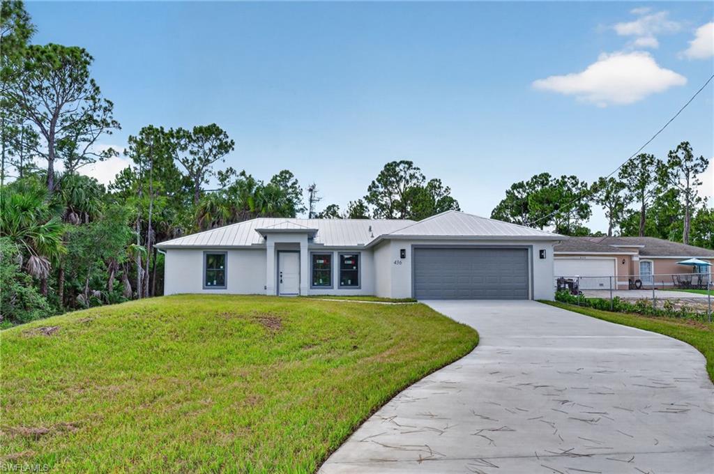 One or more photo(s) has been virtually staged, AI generated or rendered.  Modern New Construction on 100% UPLANDS Acreage in Growing North Naples Corridor
Experience the perfect blend of modern construction, privacy, and long-term value in this 2025-built residence located in highly desirable Golden Gate Estates. Situated on 1.14 acres of 100% uplands, this property offers both peace of mind and flexibility rarely found at this price point.
Thoughtfully designed with quality and durability in mind, this home features a metal roof, full concrete driveway, and a whole-home reverse osmosis water system. The exterior setting provides ample space for future enhancements while maintaining a clean, modern curb appeal.
Inside, the open-concept floor plan creates a bright and inviting atmosphere ideal for both everyday living and entertaining. The kitchen flows seamlessly into the main living area, complemented by stainless steel appliances, quartz finishes, and modern cabinetry.
The split-bedroom layout ensures privacy, with spacious secondary bedrooms and a well-appointed guest bath featuring dual sinks. The primary suite offers a relaxing retreat with a walk-in shower, dual vanities, and a clean, contemporary design.
Located just minutes from the rapidly expanding Immokalee and Randall corridor, this property offers convenient access to new shopping, dining, and infrastructure growth while maintaining the privacy and space of estate living.
A rare opportunity to own new construction on fully usable upland acreage in one of Naples’ fastest-growing areas.