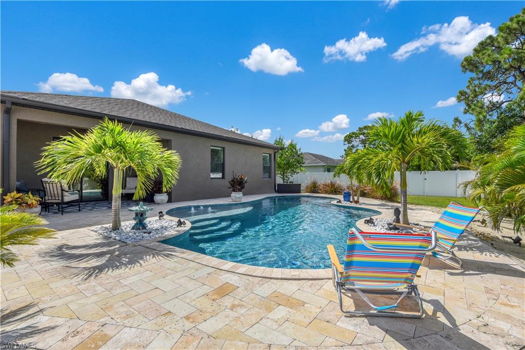 STUNNING OUTDOOR LIVING SPACE! This home that was just built in 2017 and very gently used offers outdoor living space that is a ONE of a kind  - custom built pool w/ travertine pool deck, heat & lighting Pentair system controlled by app on phone/tablet, UV sterilizer, Aqua Cal heater, 5'6" depth in center, 7' bench w/ 4 therapy jets on separate pump. spacious tanning ledge w/ 3 LED bubblers, 5 lights in pool, and commercial grade filtration system. Situated on an oversized corner lot w/ fully fenced backyard, living & family room layout, large kitchen w/ tile backsplash & stainless steel appliances(2019), formal dining area off of living room, lots of storage space, volume ceilings, and tile flooring throughout (replaced 2019 along with baseboards). Whole home solar installed! 
Home is being offered furnished! Including all outdoor furniture, grill, decor etc.   Perfect home for a vacation rental. SW Cape Coral is a highly desired area of the city and has easy access to both the Midpoint Bridge and the S Cape Coral bridge.